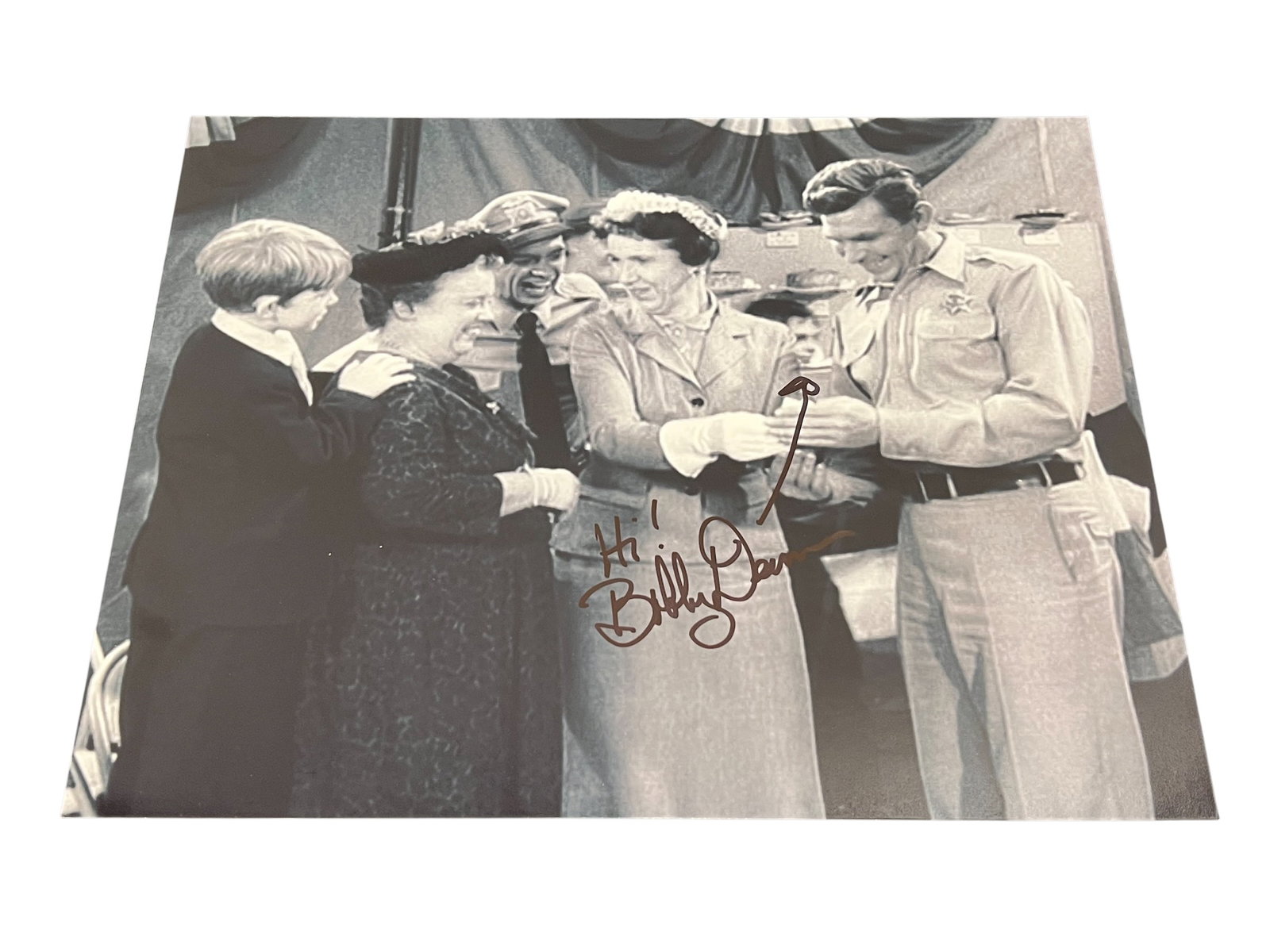 Signed Bobby Dean Photograph: This autographed photograph depicts a scene from The Andy Griffith Show episode "The Pickle Story" featuring characters Andy Taylor, Aunt Bee, Opie, and Barney Fife. [1, 2]Autograph: The image include