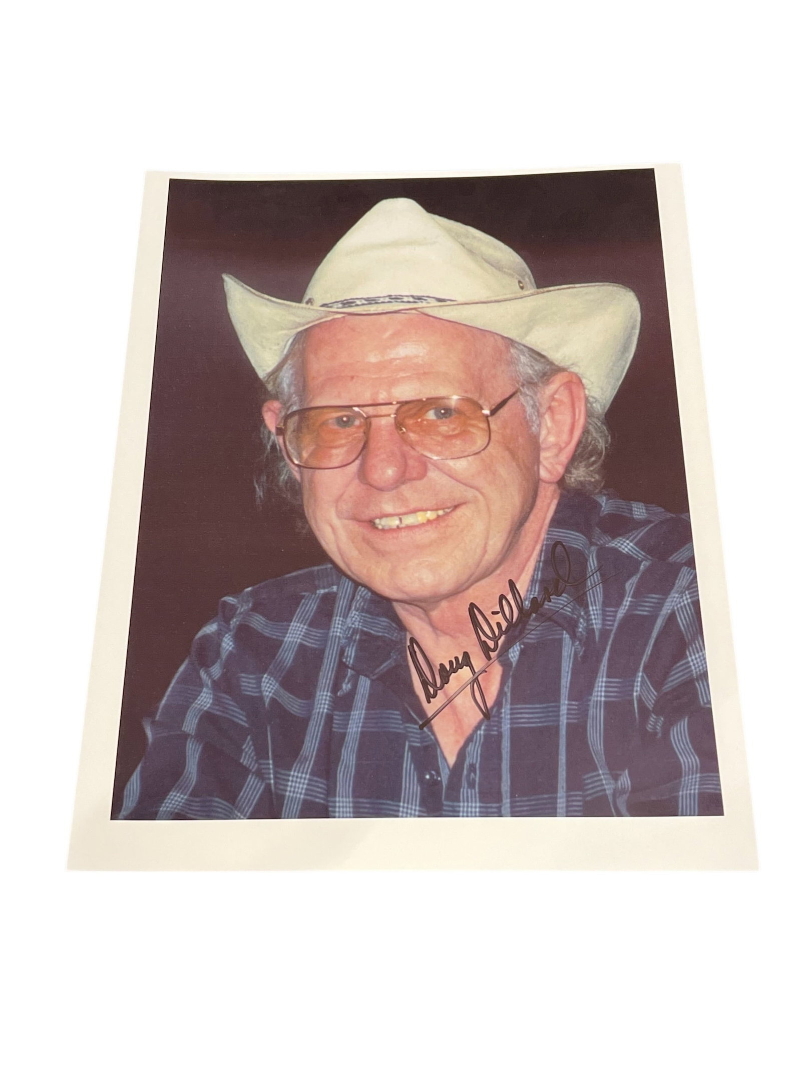 Signed Doug Dillard Photograph: This photograph appears to show Doug Dillard, known as "The Darling Boy," holding a banjo and wearing a signature straw hat. [1, 2]He was a renowned American bluegrass musician who was a member of