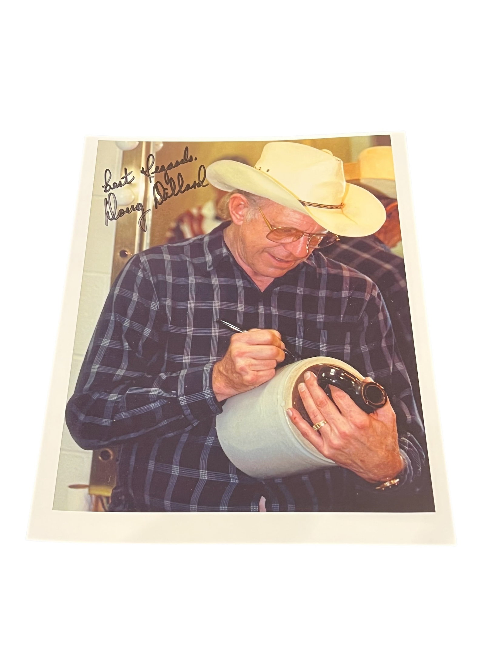 Signed Photograph: This image shows a man wearing a cowboy hat and a plaid shirt, signed "Best Regards, Doug Dillard."Doug Dillard was a renowned American banjo player and a pioneer in bluegrass music.He was a key