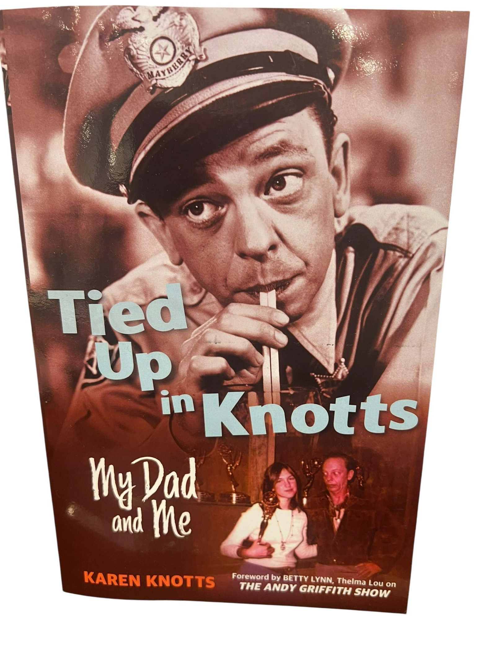 “Tied Up in Knotts?? Book: This image shows the book cover for Tied Up in Knotts: My Dad and Me by Karen Knotts, which features a prominent image of actor Don Knotts as Barney Fife. [1, 2]About the Book: This memoir, written