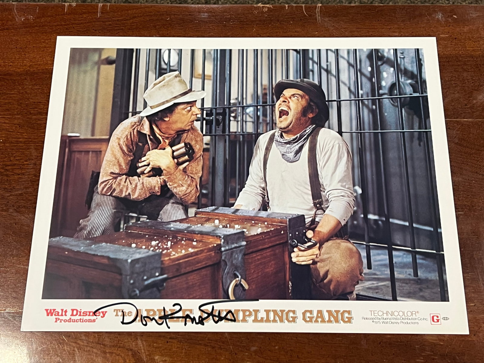 Autographed “The Apple Dumpling Gang" Lobby Card: This image appears to be an original 1975 lobby card for the Disney film "The Apple Dumpling Gang" featuring actors Don Knotts and Tim Conway. [1, 2]Cast: The card features comedy duo Don Knotts and T