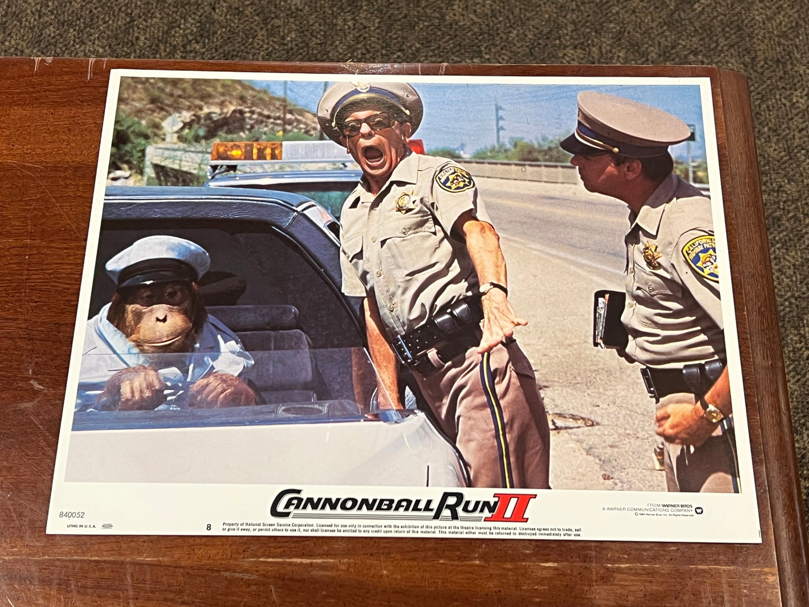 “Cannonball Run II" Lobby Card: This is an original lobby card for the 1984 comedy film Cannonball Run II.The scene features actors Tim Conway and Don Knotts interacting with an orangutan driving a car.It is part of a set of 8 diffe
