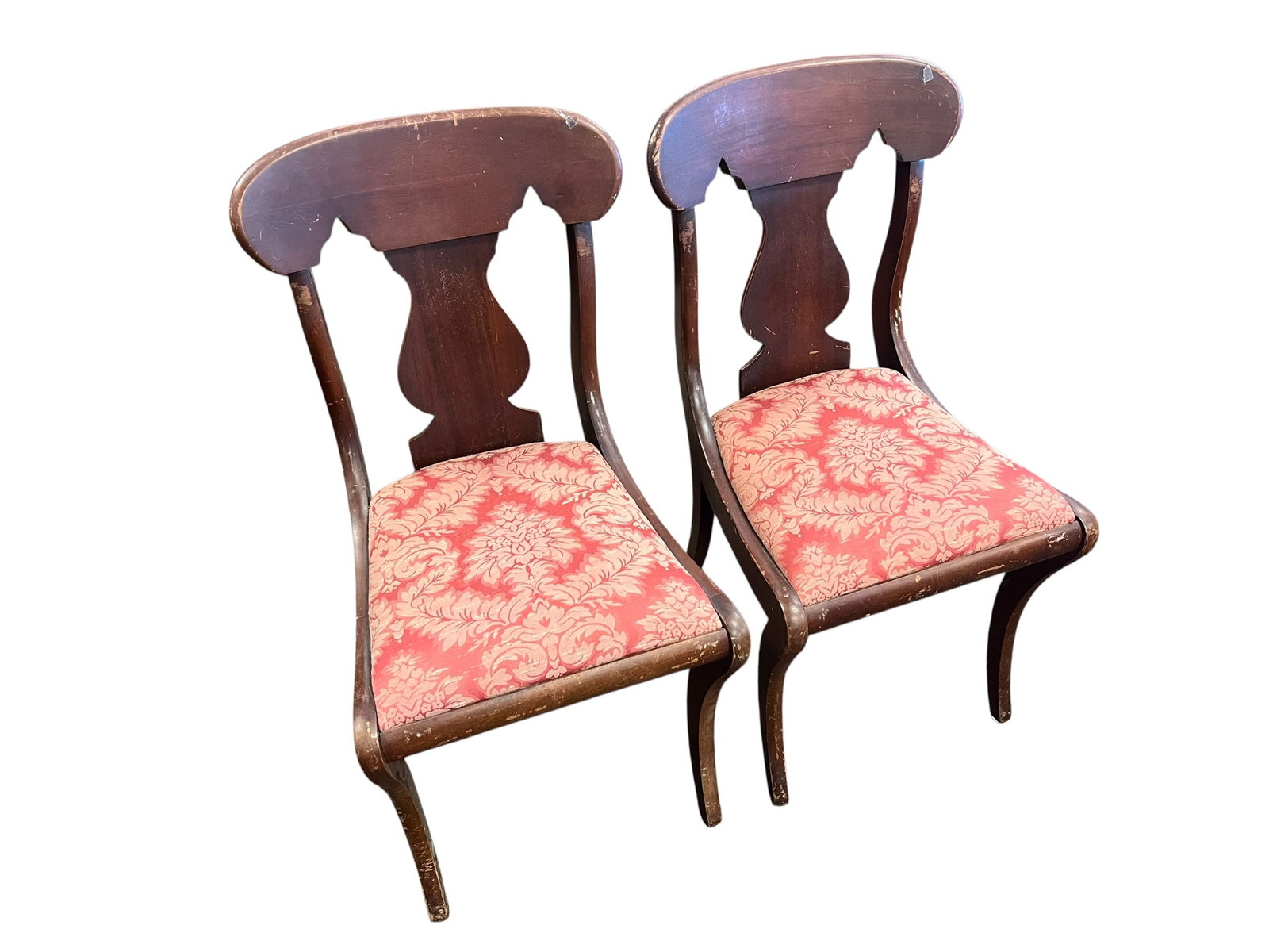 Pair of Empire Style Side Chairs: The chairs shown are American Empire style dining chairs, also commonly referred to as fiddle-back or gondola-style side chairs. Pieces sharing this precise silhouette and woodwork layout have been