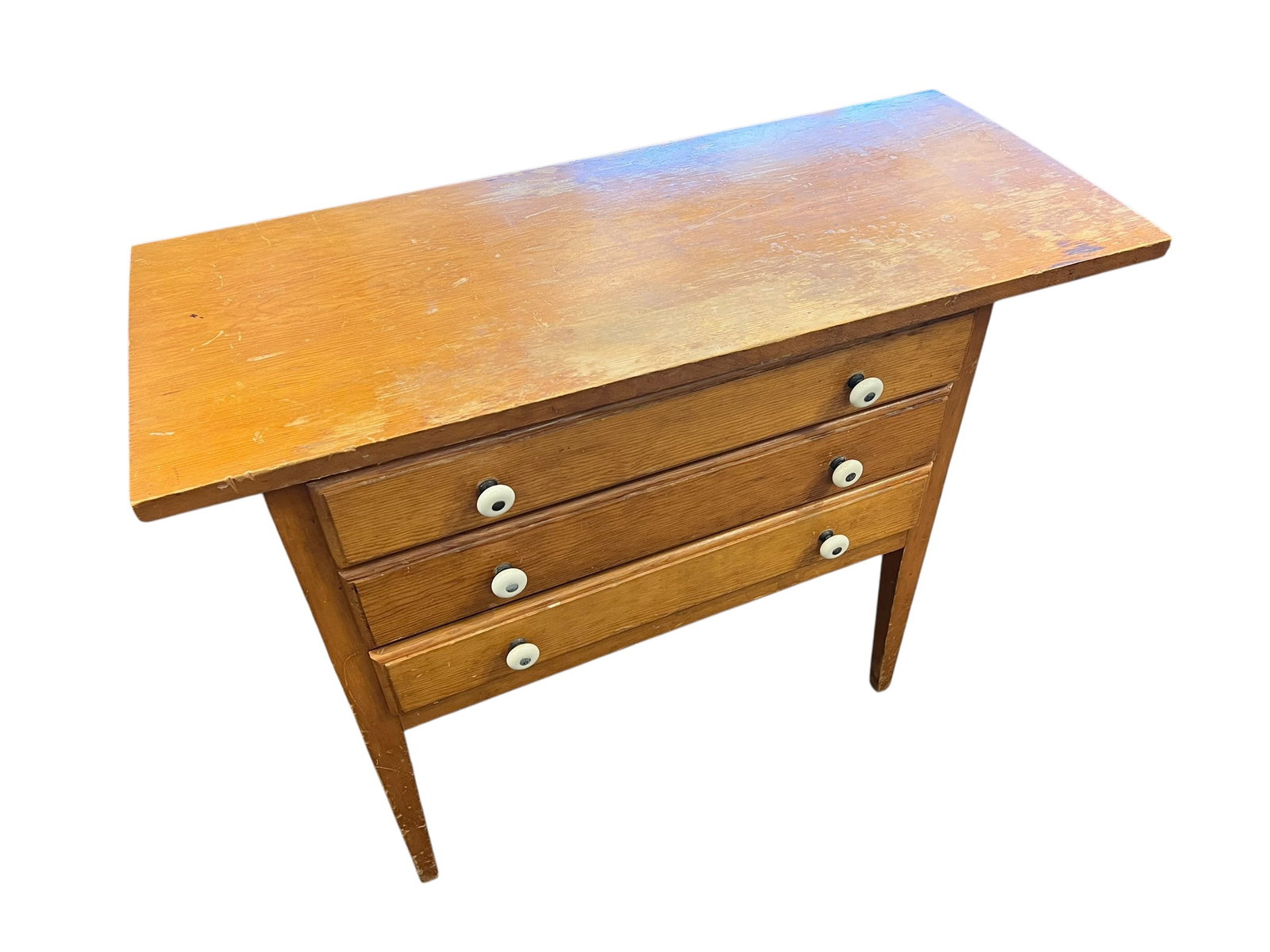 Oak Drop leaf Chest: This piece of furniture is a vintage wood three-drawer chest, often designed as a compact chest of drawers or integrated into a mid-century style sewing machine cabinet. The style features clean