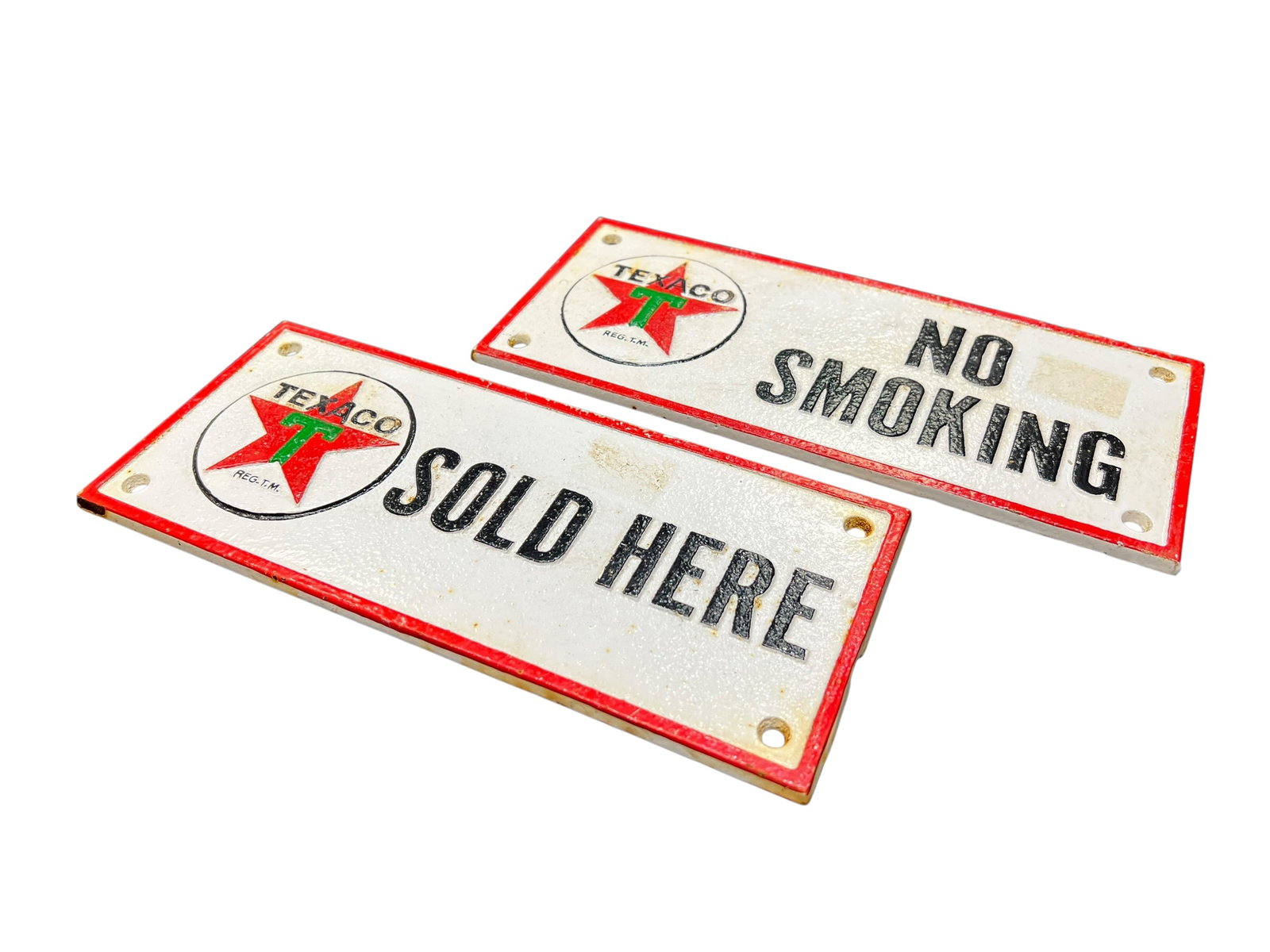 Pair of Cast Iron Texaco No Smoking Plaques: The image shows a set of two heavy vintage-style Texaco advertisement plaques, including a "Sold Here" sign and a "No Smoking" sign. These rectangular plaques feature the classic white, red, and