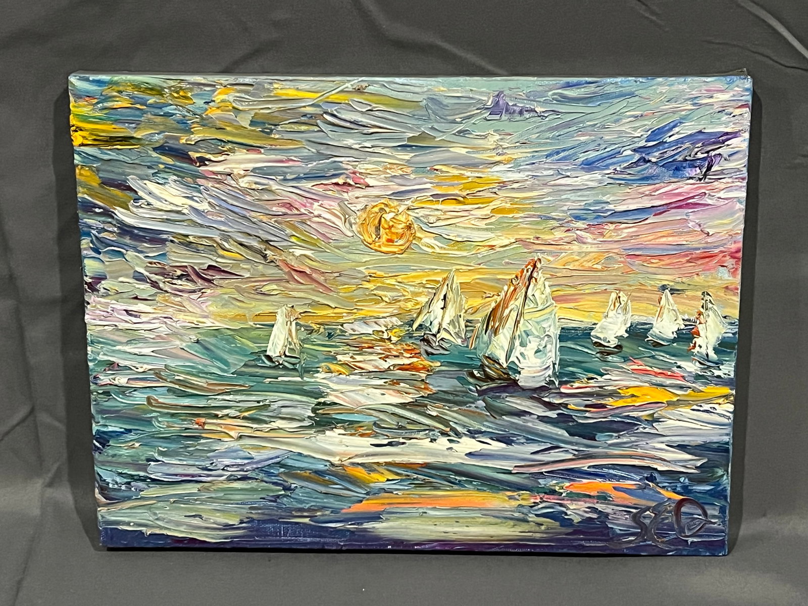 66Signed Sarah Davis “Sail Away?? Oil on Canvas: This image shows an original impasto seascape painting featuring several sailboats at sunset. The composition is defined by its thick, textured application of oil or acrylic paint, creating a highly