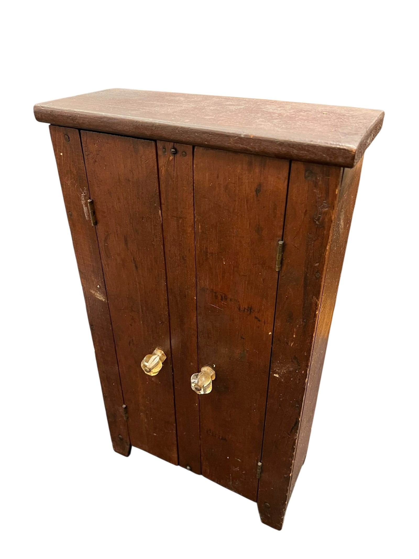 Miniature American Primitive 2 Door Cupboard: This is a vintage or antique primitive wooden wall or tabletop cabinet, likely hand-crafted from pine or a similar soft wood. [1]Key FeaturesMaterial & Build: Solid rustic wood planks with visible gra