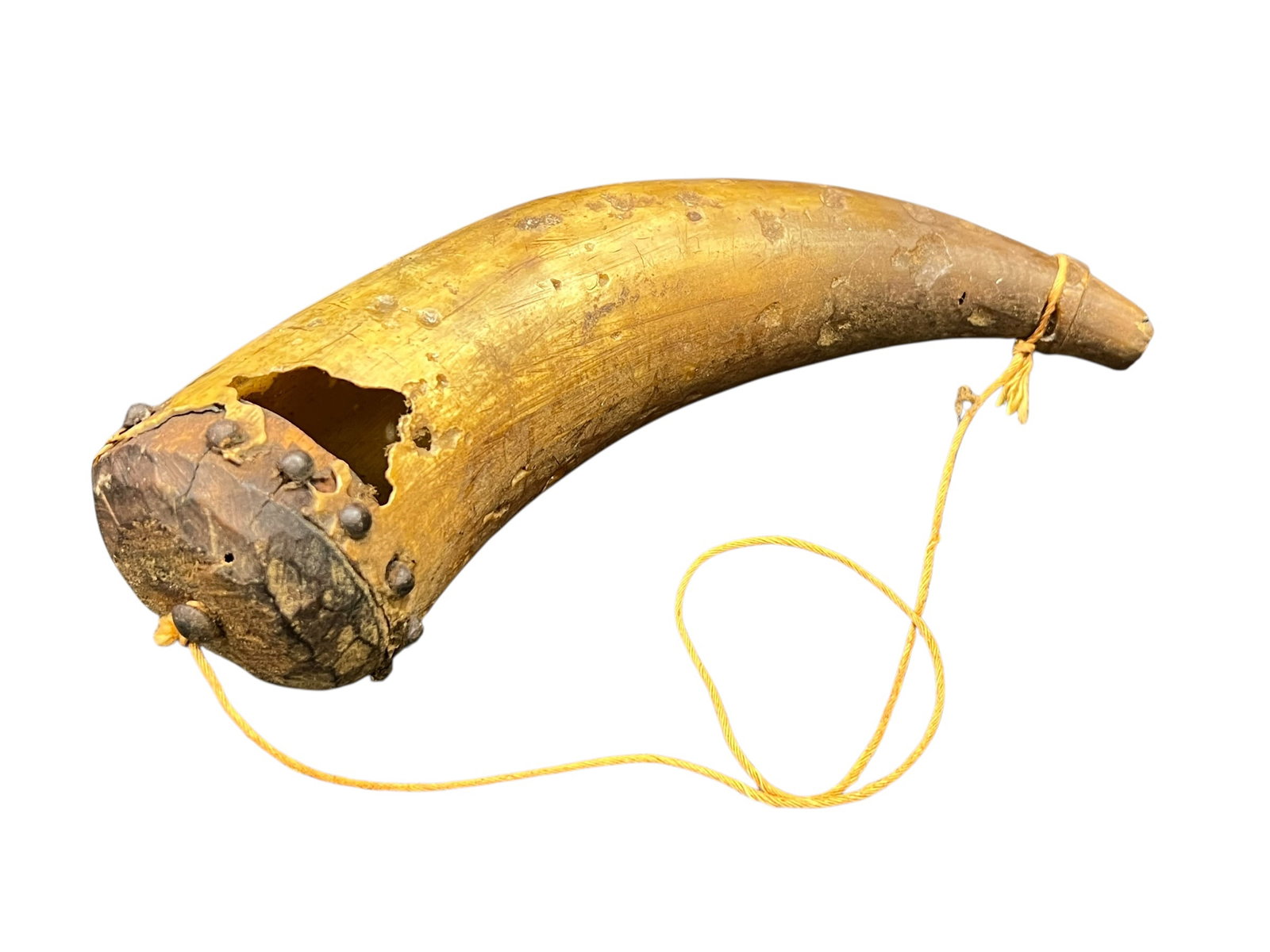 Powder Horn: This is an antique 19th-century North American or frontier powder horn, typically fashioned from a hollowed bovine horn with a wooden base plug secured by metal tacks and fitted with a carrying