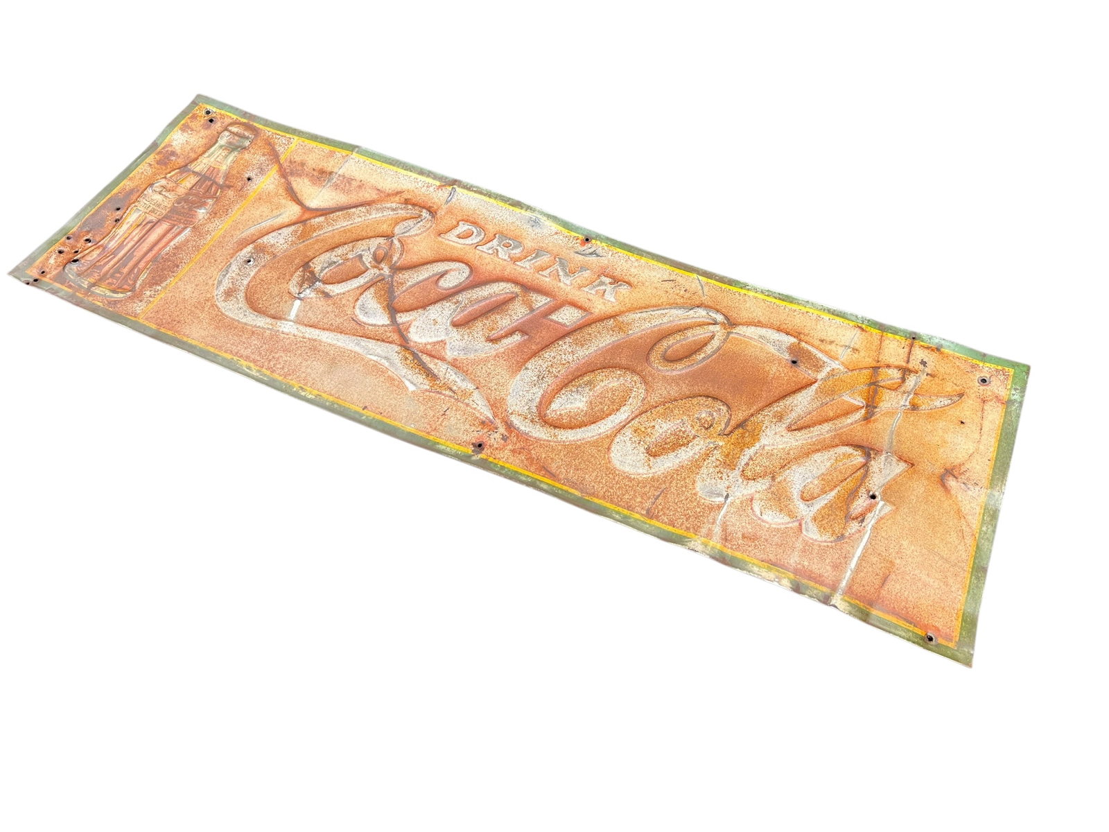 Coca Cola Sign dated 1930’s: This appears to be a vintage embossed metal "Drink Coca-Cola" sign featuring a classic contour bottle graphic and heavy rusted patina.Features: Embossed script logo, "Drink" in an arched banner at