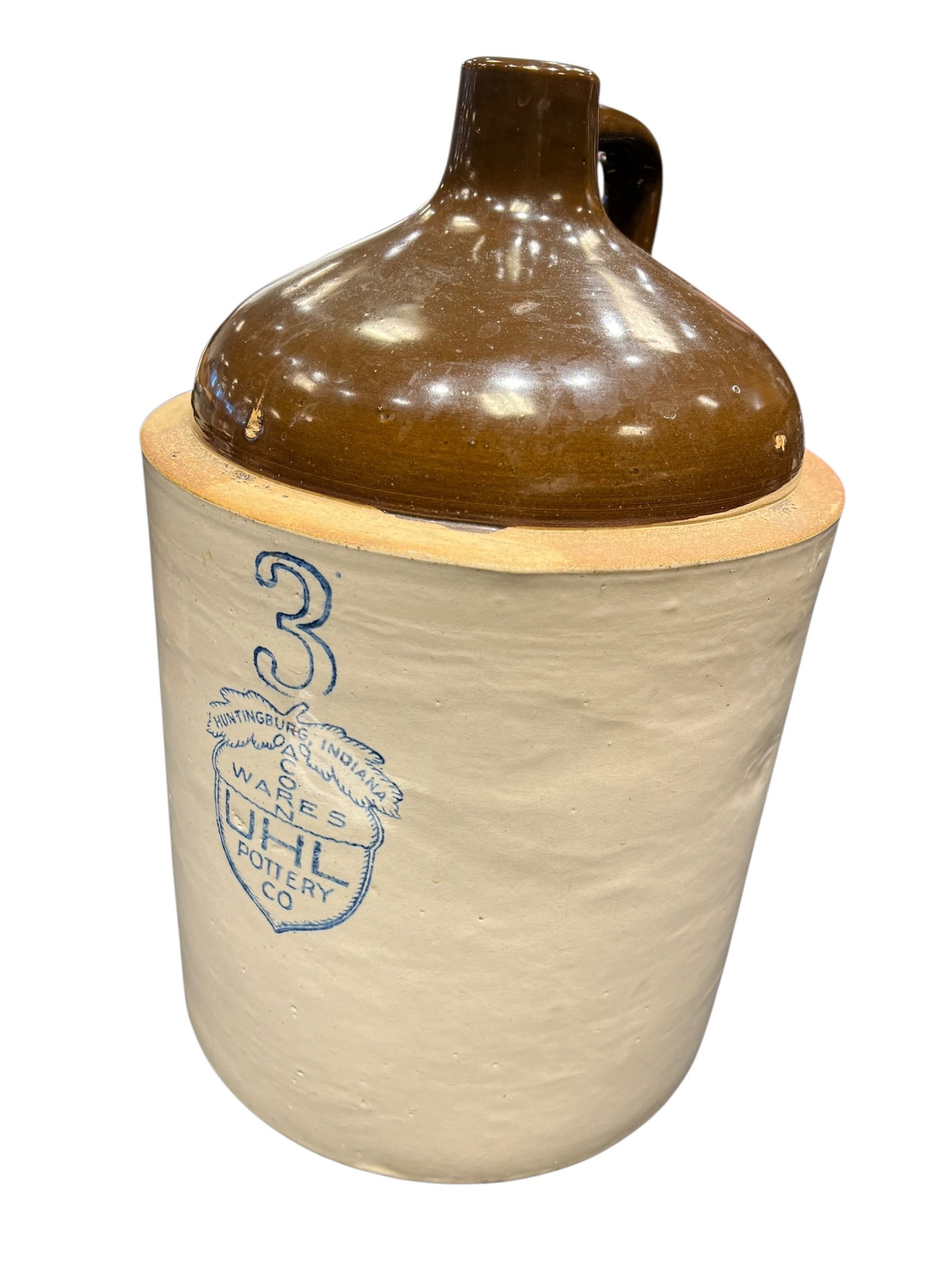 3 Gallon Stoneware Jug: This is an antique 3-gallon stoneware shoulder jug featuring a cobalt blue "Acorn Wares" stamp from the Uhl Pottery Company of Huntingburg, Indiana, produced roughly between 1908 and the 1940s. [1,