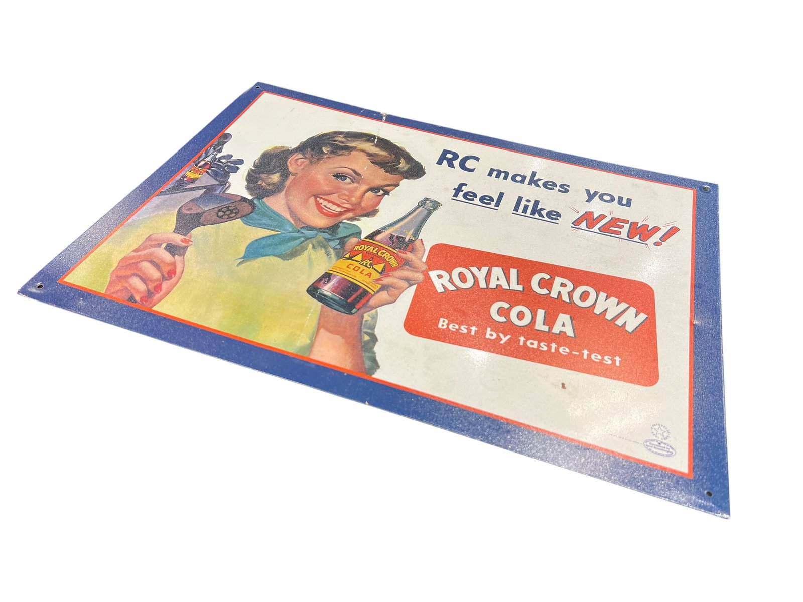 Royal Crown Cola Metal Advertising Sign: This is a vintage lithographed cardboard advertising sign for Royal Crown Cola (RC Cola), dating back to the 1930s or 1940s and featuring the famous slogan "Best by taste-test". [1, 2]Sign DetailsBran