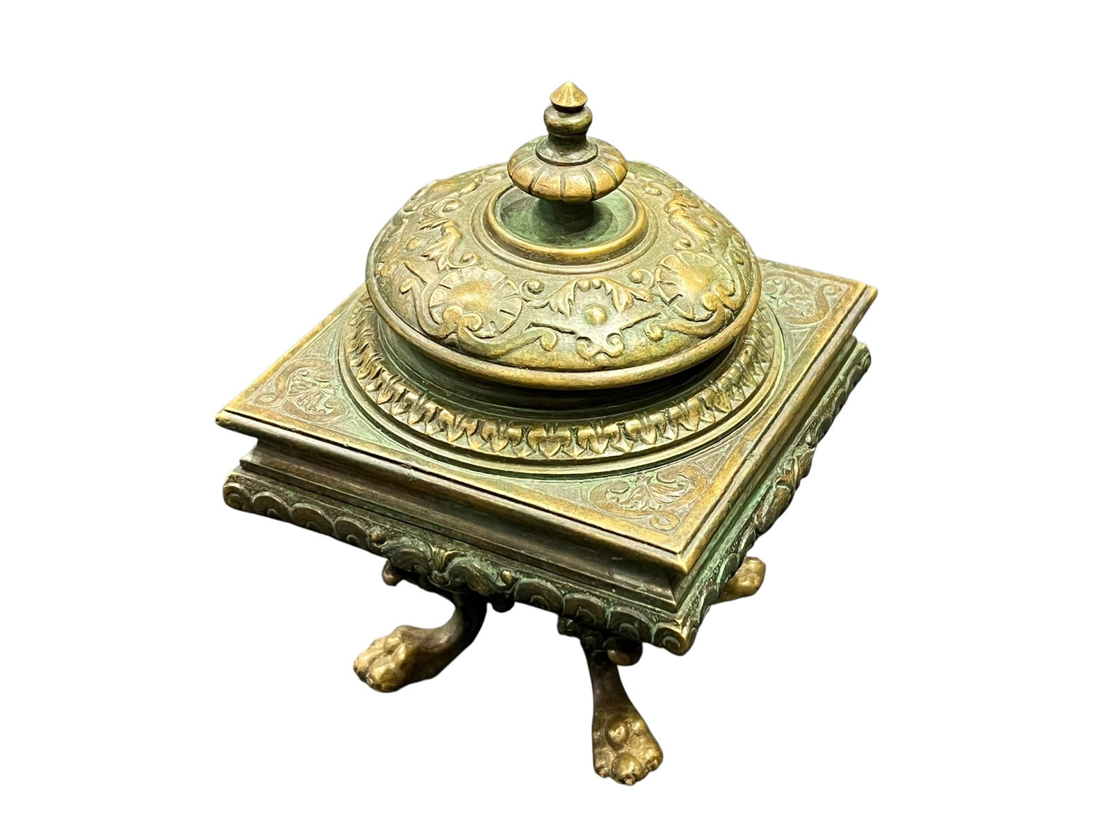 Tiffany & Co..Bronze or Brass Desk Inkwell: This object is an antique cast brass claw-foot desk inkwell, originating from the late 19th-century Victorian era. It features an ornate square platform supported by detailed animal paw legs, a