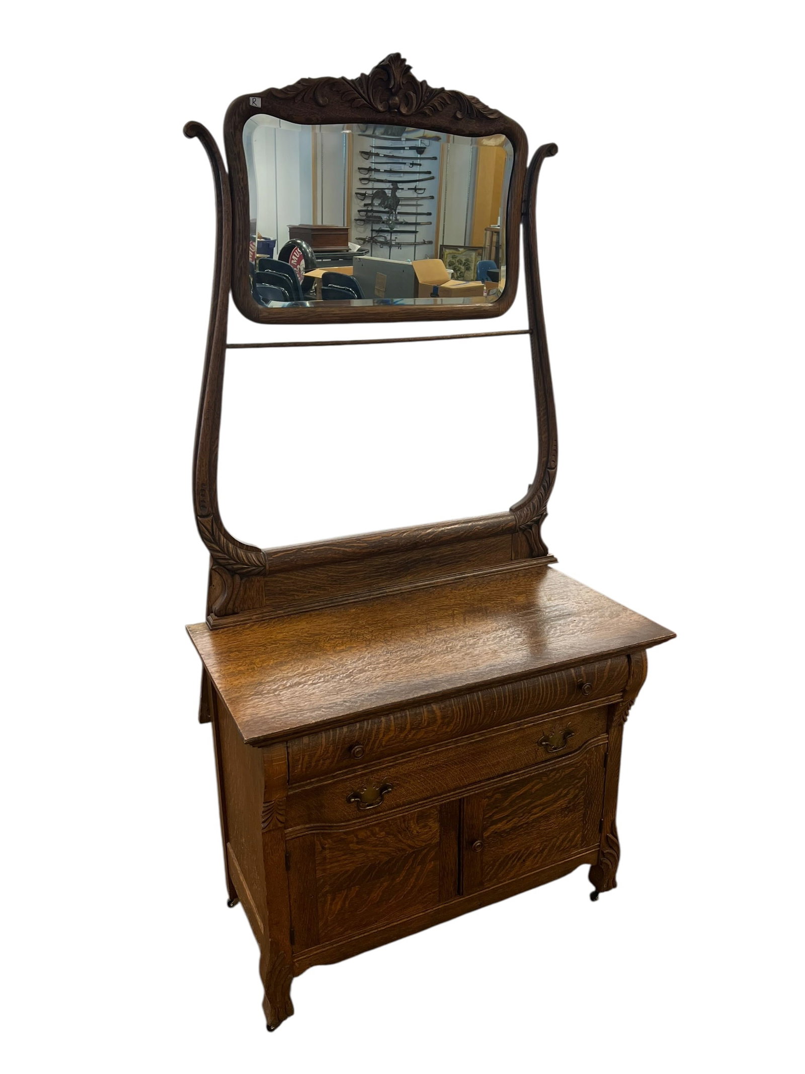 Oak Wastand with Mirror: This antique Victorian-era quarter-sawn oak washstand features an upper swiveling beveled mirror, a lower cabinet with two paneled doors, and a single serpentine drawer. [1, 2, 3, 4]Key FeaturesWood: