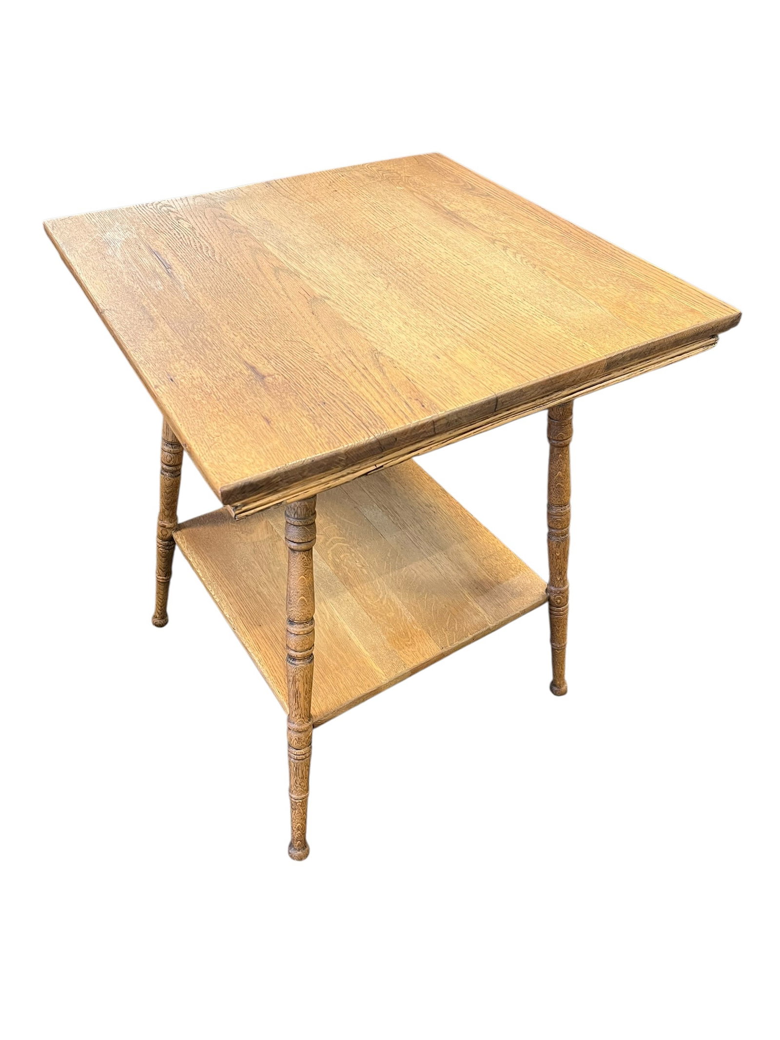 Oak Lamp Table: This furniture piece is an antique 2-tier American parlor table, constructed from solid oak and featuring distinctive bobbin-turned (spool) spindle legs. [1, 2, 3]Notable Characteristics & Design Elem