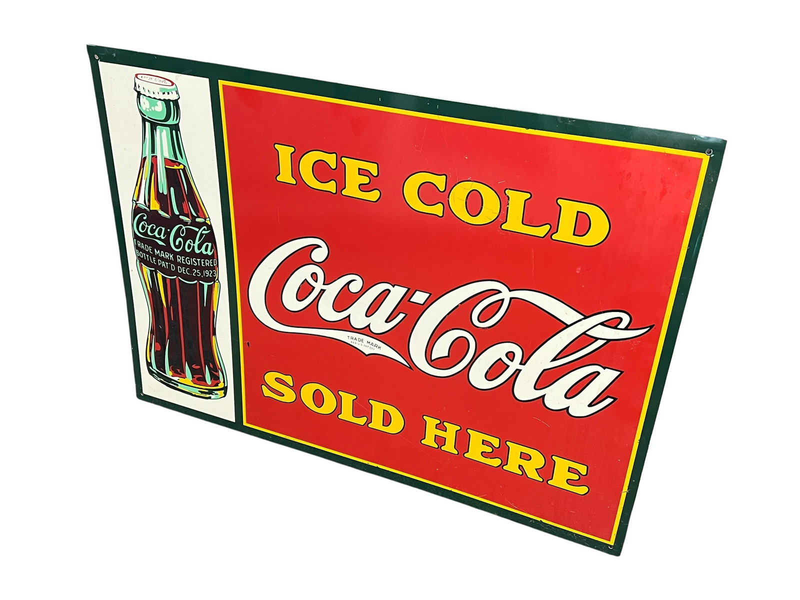 Coca Cola Advertising Sign: This item is a vintage-style Coca-Cola "Ice Cold Sold Here" metal tin sign featuring a classic green-trimmed border, red background, and a vintage contour bottle graphic. [1, 2]Design: Displays the cl
