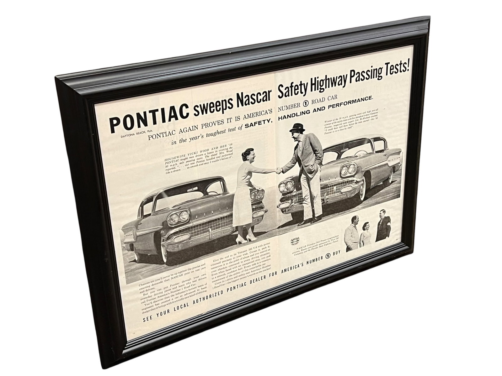Pontiac Advertising Poster: This framed vintage 1958 Pontiac magazine advertisement highlights the NASCAR Safety Highway Passing Tests won by driver Vicki Wood with a '58 Pontiac. [1]Subject: Original 1958 Pontiac print