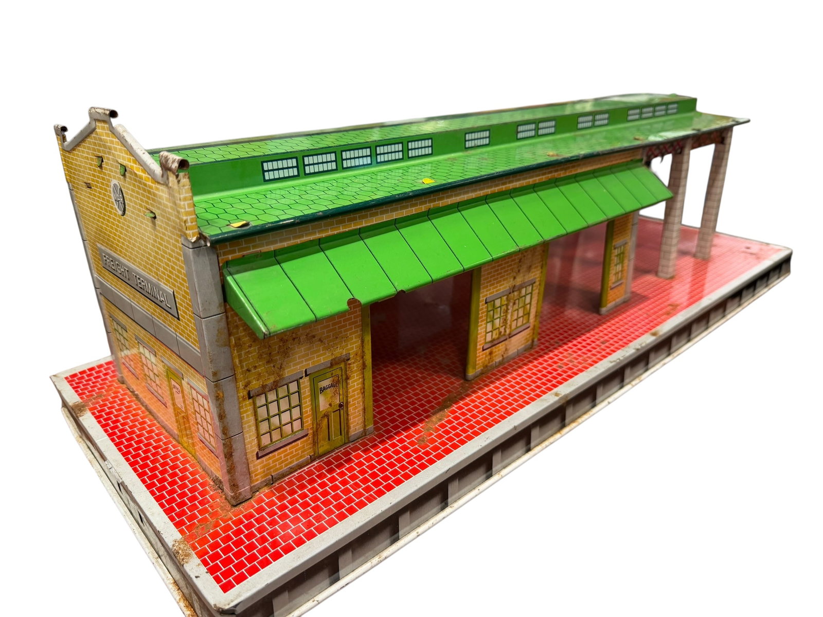 Marx Tin Litho Freight Terminal: The featured item is a vintage 1950s Louis Marx & Co. tin lithographed O gauge freight terminal station (often cataloged as model #224 or #5424). [1, 2, 3]Design: Features colorful lithographed tin