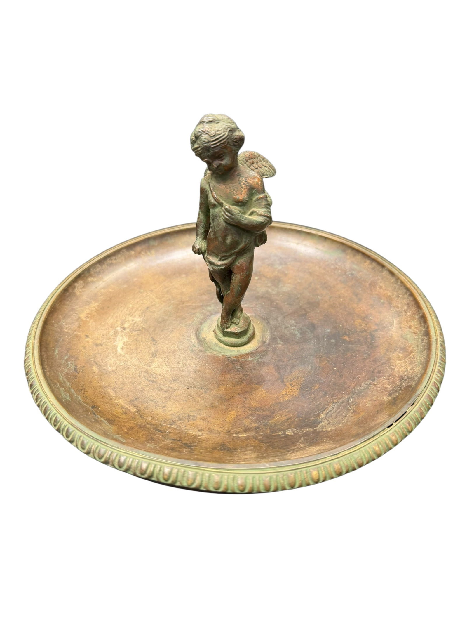 Tiffany & Co. Brass/Bronze Tabletop Centerpiece: The image displays a vintage or antique figural brass/bronze dish or ashtray featuring a standing winged cherub (putto or Eros) sculpture rising from the center of a circular tray with an egg-and-dart