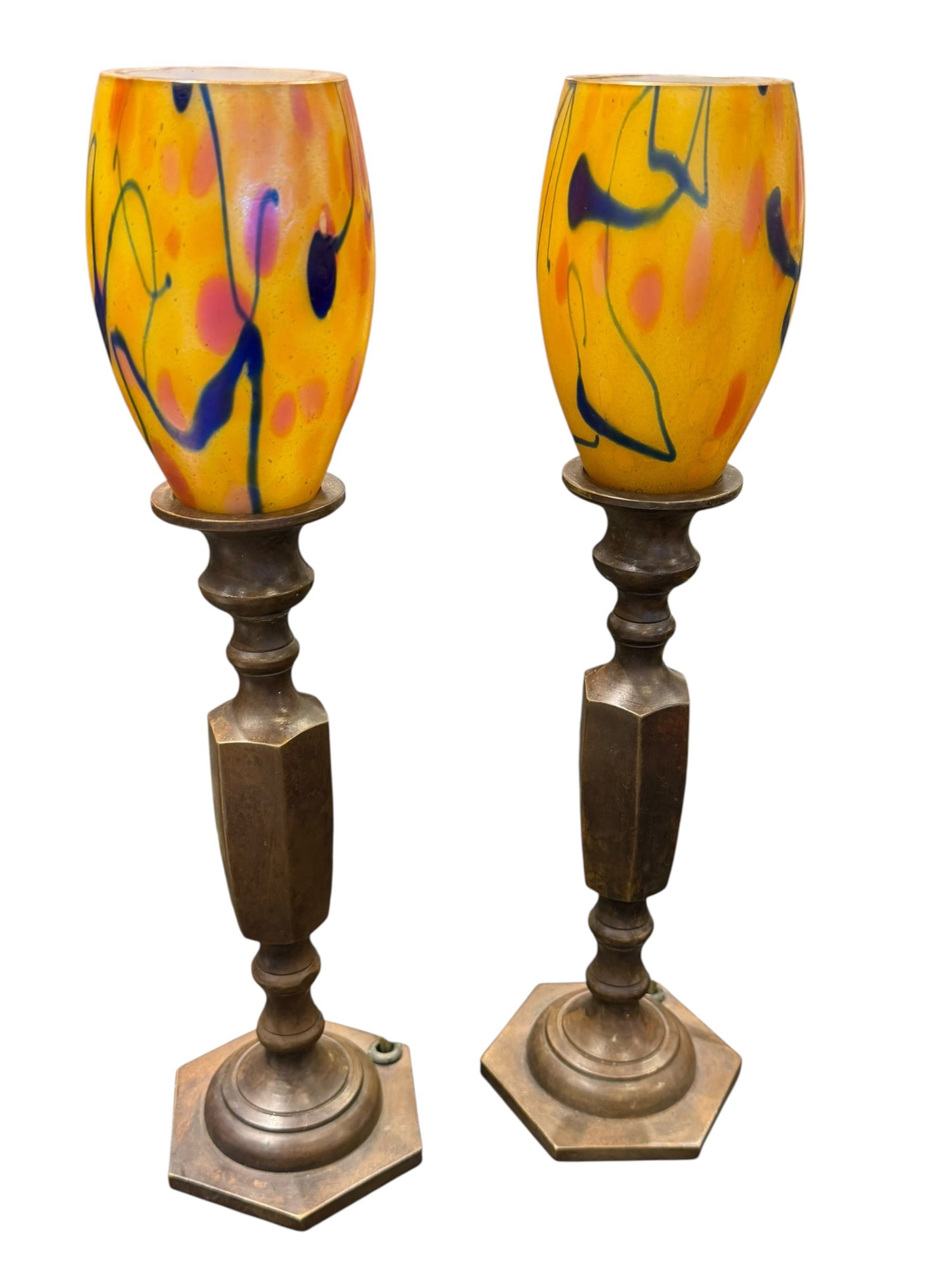 Pair of Tiffany & Co. Lamp Bases with Durano Lamp Shades: These decorative candle lamps feature hand-blown spatter/splatter art glass shades with bright yellow, pink, and blue abstract splashes, mounted on heavy patinated bronze or brass hexagonal candlestic