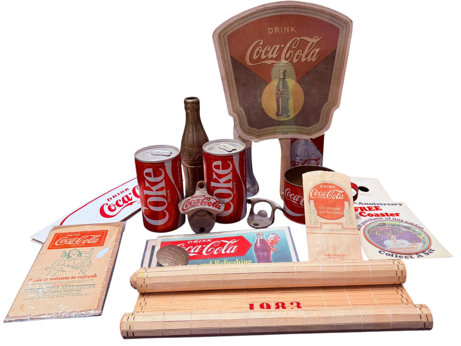 Lot of Coca Cola Memorabilia: This image displays a collection of vintage and modern Coca-Cola promotional and commemorative memorabilia. [1, 2]Key Items Included:Two classic "Coke" design soda cans and a miniature glass contour b