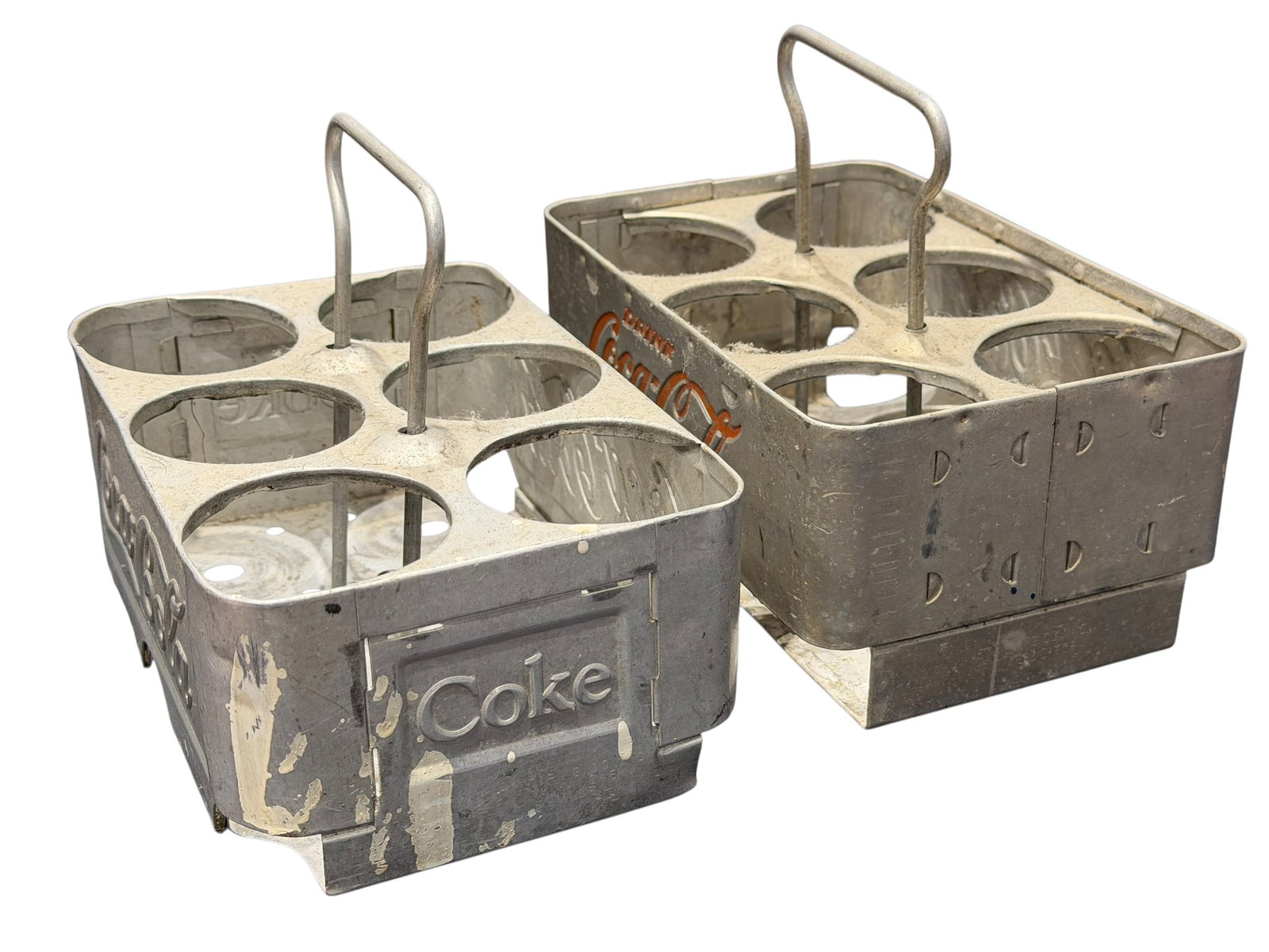 Lot of 2 Aluminum Coca Cola Advertising 6 Pack Carriers: These items are vintage mid-20th-century Coca-Cola 6-pack aluminum bottle carriers, often manufactured by companies like Acton Manufacturing Co. during the 1950s. [1]Key FeaturesMaterial: Pressed and 