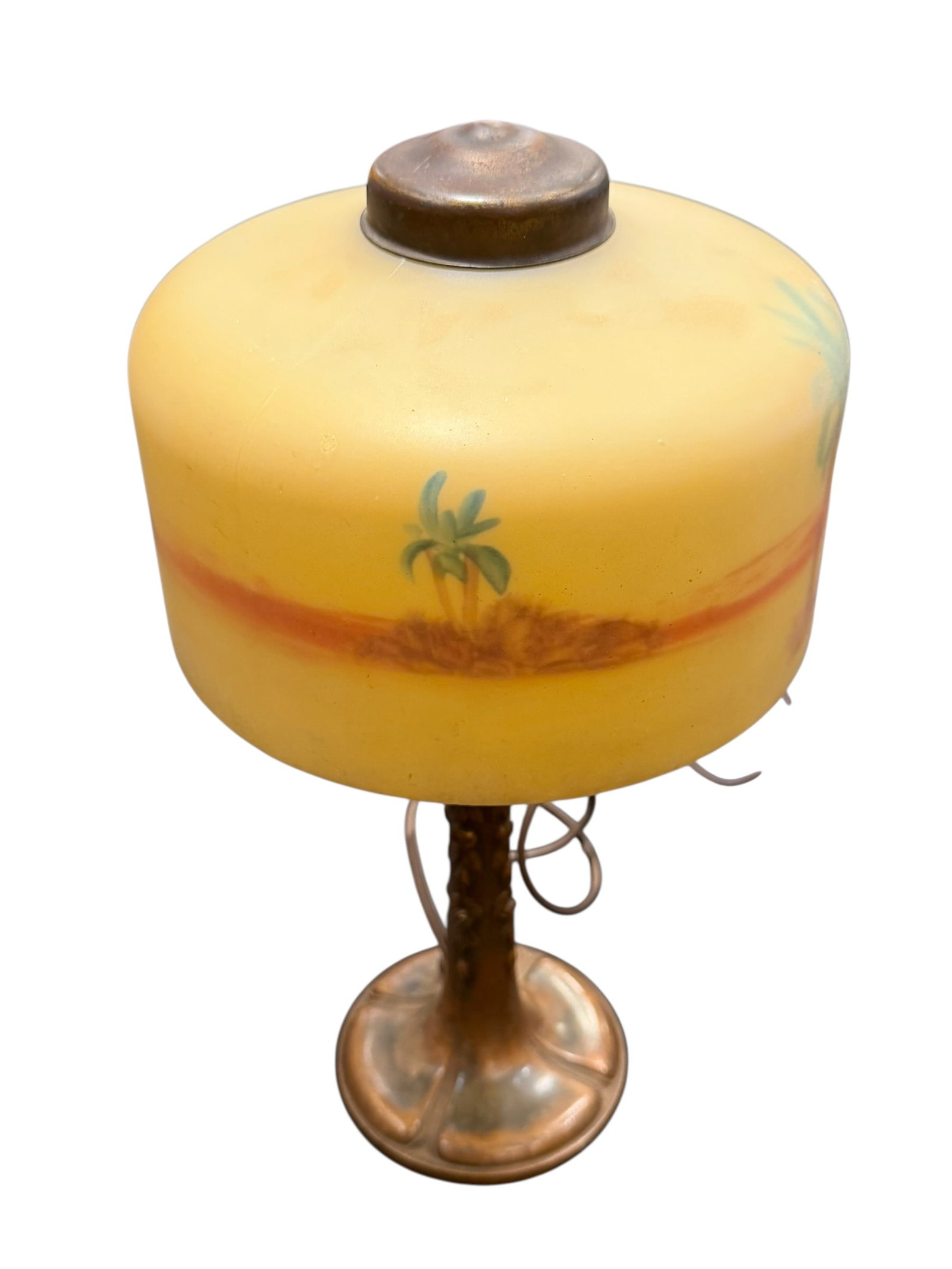 Reversed Glass Painted Lamp: This vintage reverse-painted glass table lamp features a tropical sunset scene with palm trees against a warm yellow and orange horizon on a patinated metal base. [1, 2]Style/Era: Early-to-mid 20th
