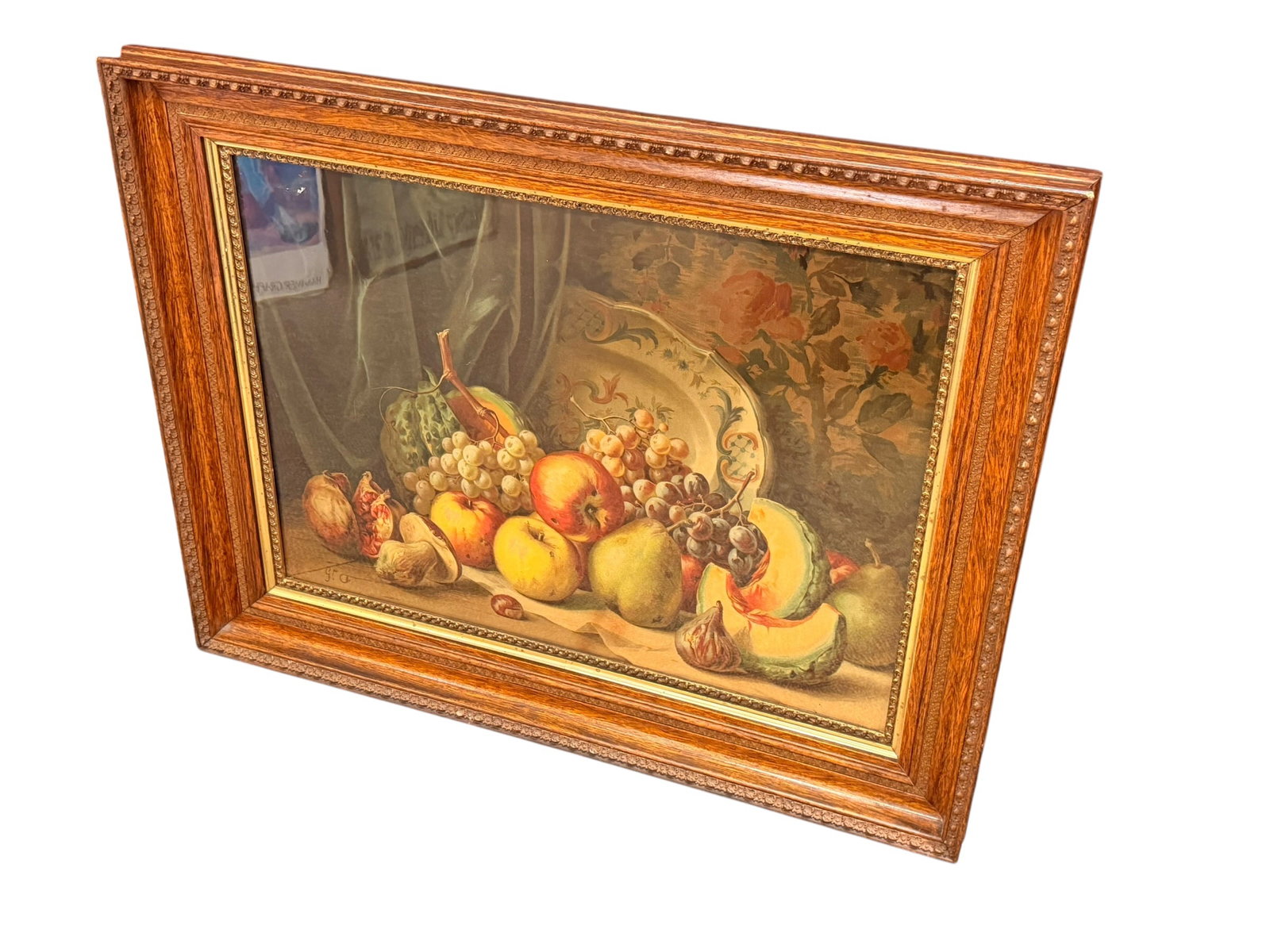 Signed Framed Still Life Print: This piece is a late 19th-century French fruit still life oil painting. The composition features a rich arrangement of summer fruits—including apples, pears, grapes, and sliced melon—gathered alon