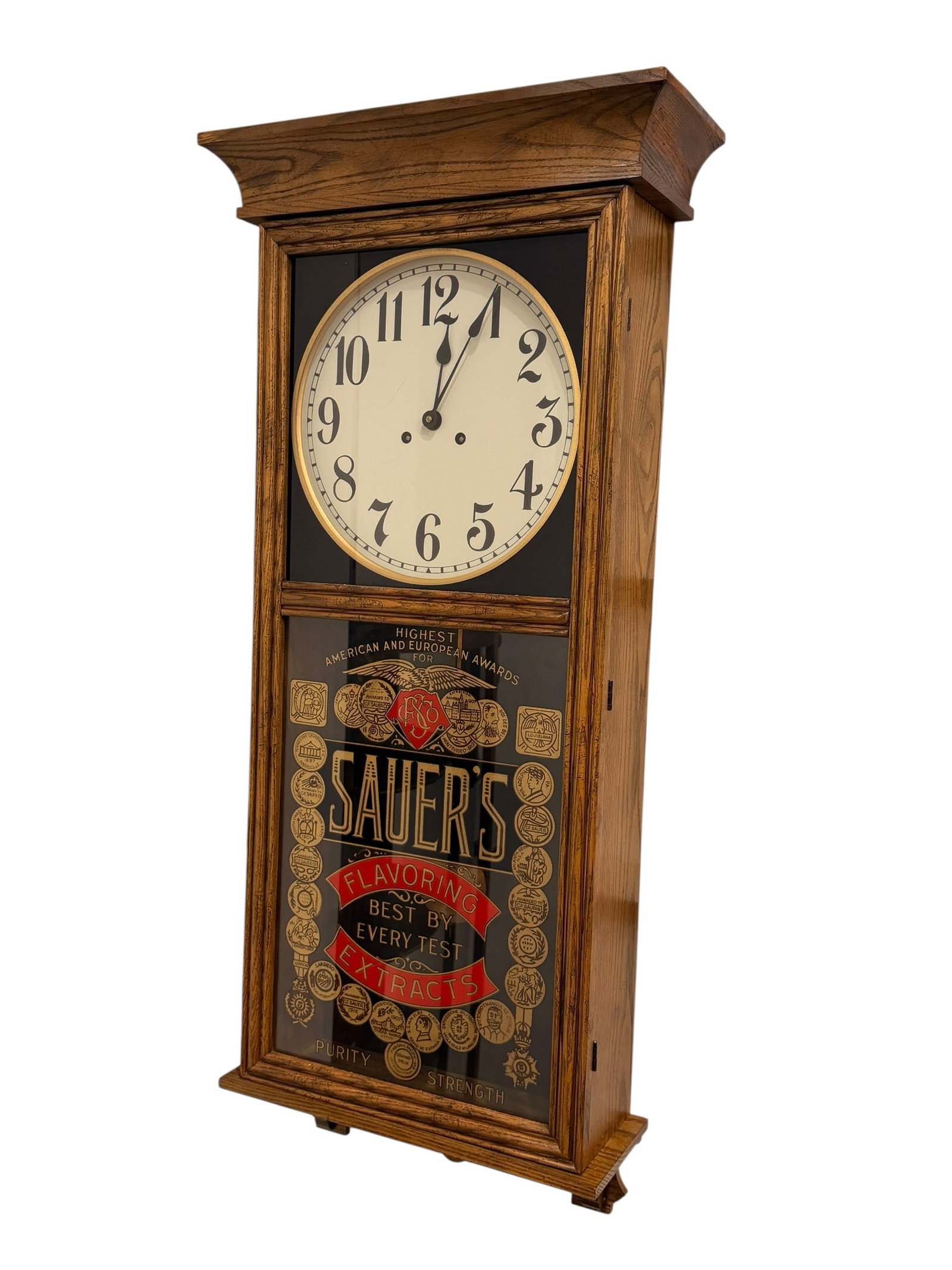 Saurs Advertising Clock: This antique Sauer's Flavoring Extracts advertising wall clock features an oak case and a reverse-painted glass door panel, typically produced by makers like the New Haven Clock Co. or William L.