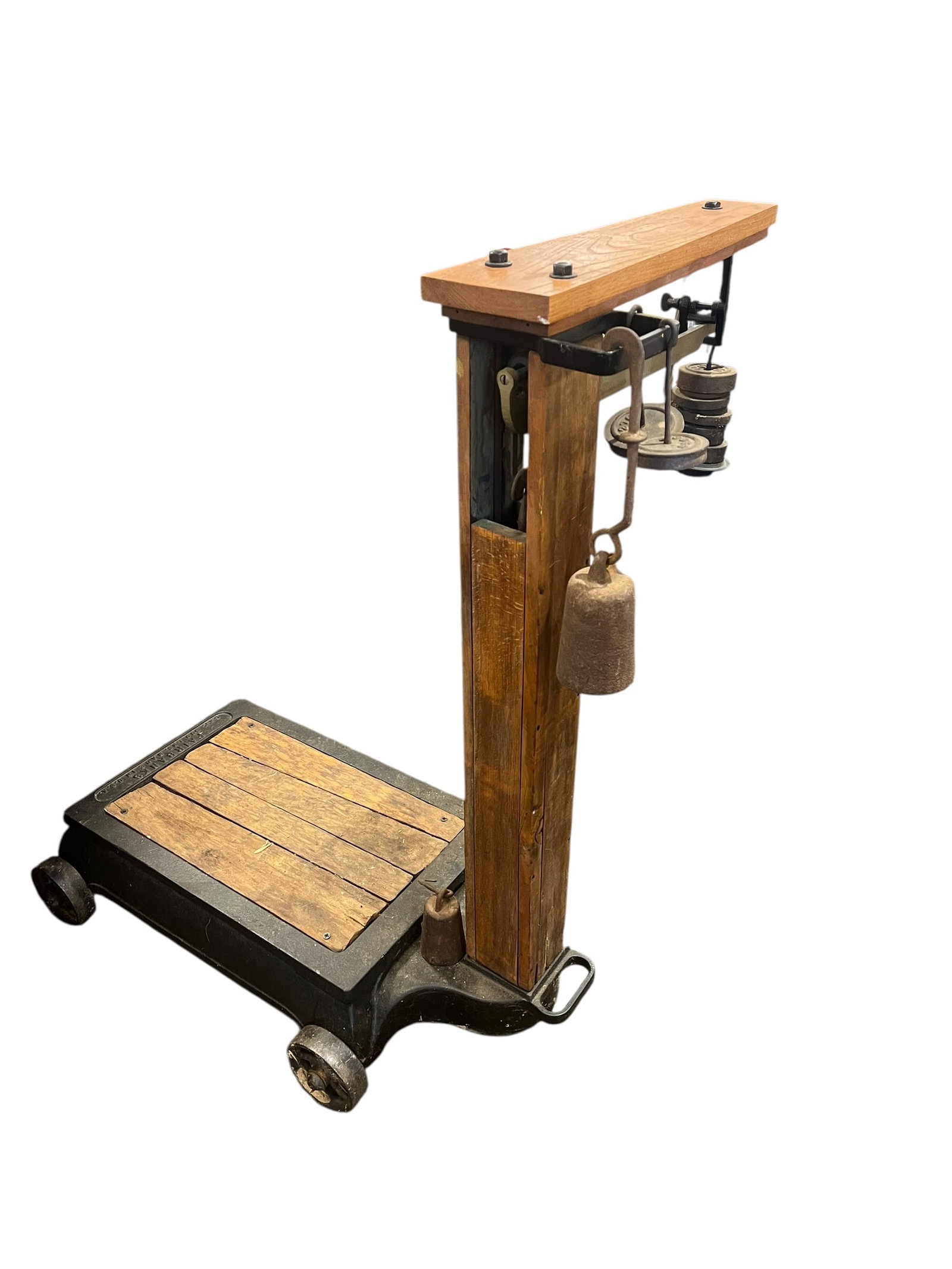 Early Railroad Scale: This appears to be an antique Sears & Roebuck platform scale, featuring a heavy cast iron base, wooden platform deck, and upright post with hanging counterbalance weights. [1, 2]Similar vintage