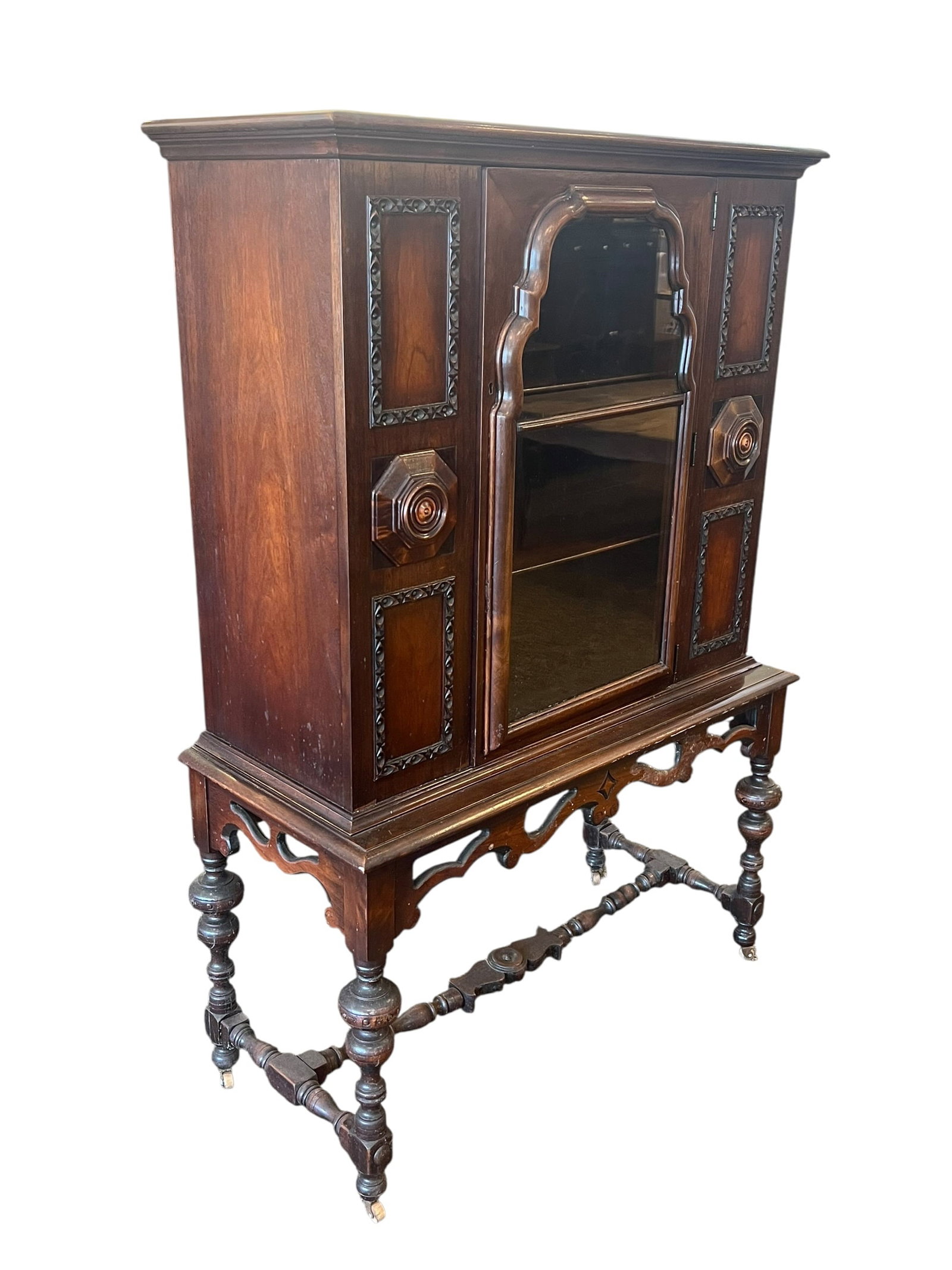 Walnut Jacobean Style China Cabinet: This is an antique Jacobean Revival display cabinet, commonly manufactured in the United States during the 1920s to 1930s (Depression Era). It is heavily inspired by 17th-century English William and