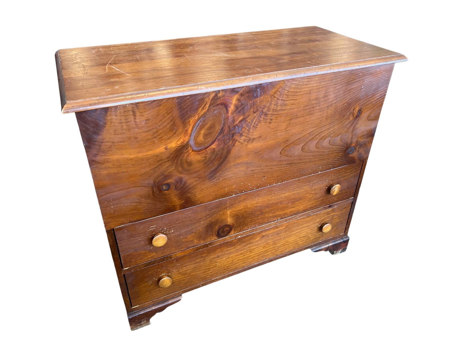 2 Drawer Dowry Chest: The image shows an antique solid pine mule chest with a lift top over two lower drawers and round wooden pull knobs. [1, 2]Type: Primitive-style lift-top blanket/mule chestMaterial: Solid wood with a