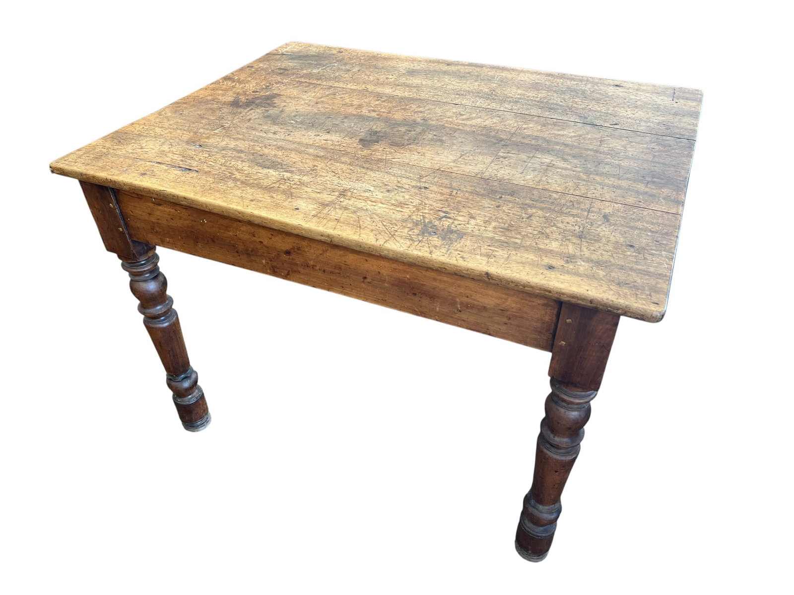 Primitive Farm Table: This item is a 19th-century French Louis Philippe bistro table, traditionally crafted from solid walnut or fir. It is characterized by its rustic, heavily patinated plank top and classic turned legs.