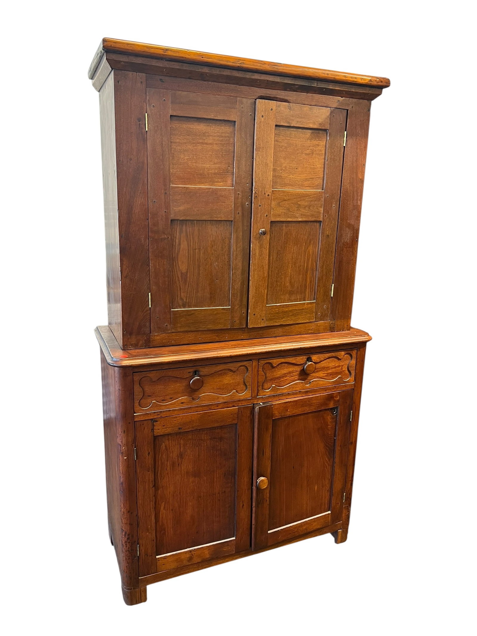 Mahogany Stepback Cupboard: This appears to be an antique mid-19th-century Southern two-piece cherry or walnut Jackson press featuring a stepped-back upper blind-door cabinet over a lower section with two carved drawers and
