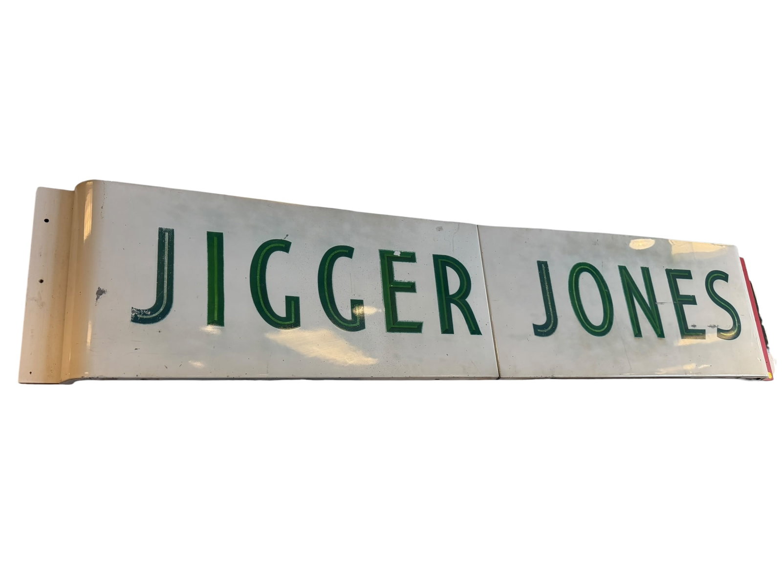 2 pc. Jigger Jones Porcelain Advertising Sign: This is a vintage porcelain enamel architectural sign featuring the name "JIGGER JONES" in bold, green lettering. [1]Historical Significance & ContextThe Folk Legend: The name likely refers to Albert
