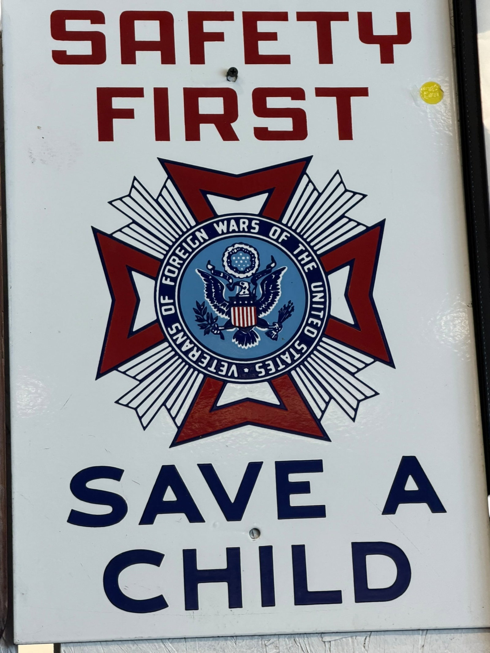 Safety First Save a Child Porcelain Sign: The image shows a vintage metal or porcelain sign featuring the emblem of the Veterans of Foreign Wars (VFW) with the bold text "SAFETY FIRST" and "SAVE A CHILD". [1, 2]This appears to be a