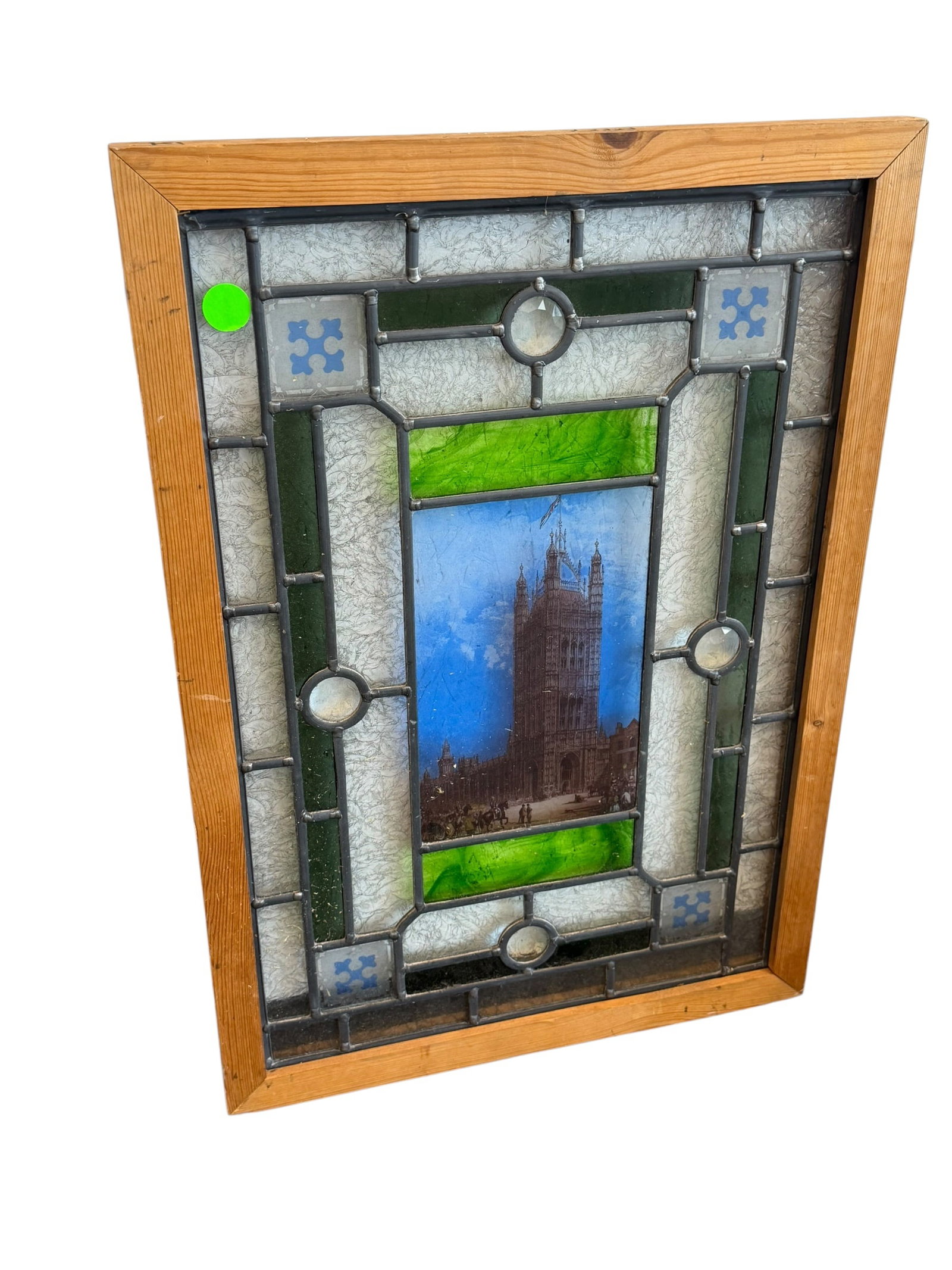 Stain Glass Window: This item is a decorative leaded stained glass panel featuring a central printed image of the Victoria Tower, which is the tallest tower of the Palace of Westminster (Houses of Parliament) in London. 