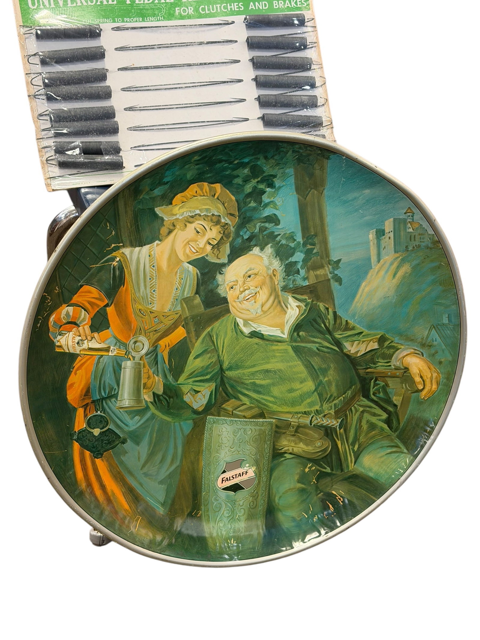 LFalstaff Advertising Tray: This item appears to be a vintage 1971 Falstaff Beer 24-inch round metal wall charger or bar display sign, featuring a classic tavern illustration of Sir John Falstaff and a beer maid.It is a piece