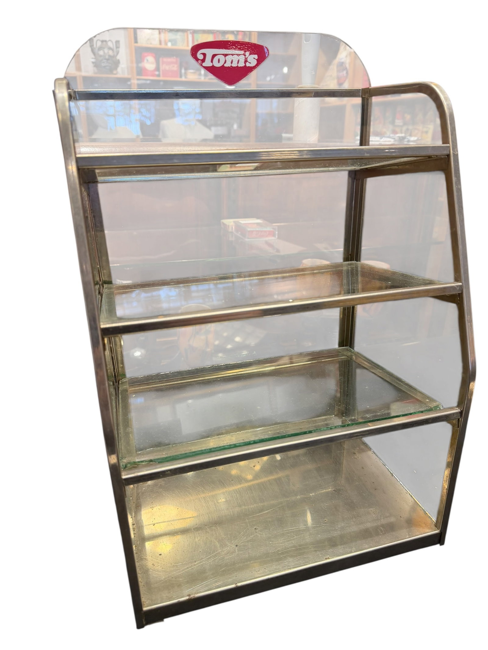 Tom’s Glass Shelf Display Rack: This appears to be a vintage Tom's Toasted Peanut countertop metal and glass display rack, featuring a multi-tiered stepped glass shelf design with a branded "Tom's" logo topper. [1, 2]It resembles