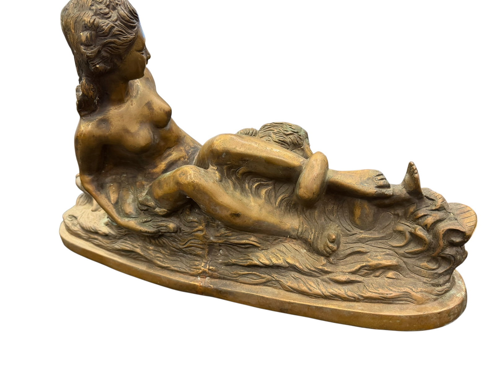 Brass/Bronze Table Top Sculpture: This image appears to show a cast bronze tabletop sculpture of a female figure reclining gracefully on a textured base resembling waves or flowing drapery. [1, 2, 3, 4]Style & Material: The piece
