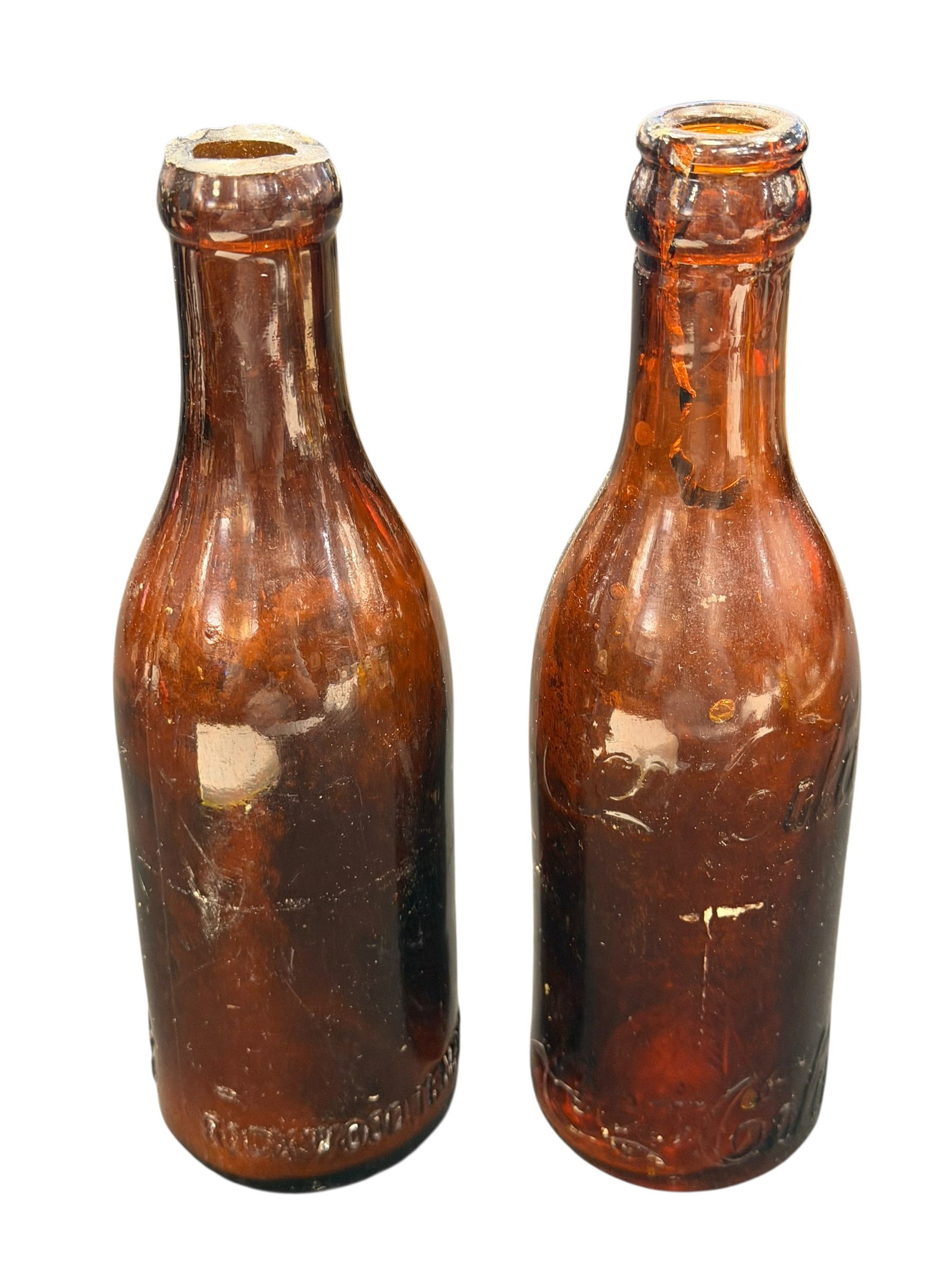 Lot of 2 Amber Glass Straight Side Coca Cola Bottles: These appear to be antique, straight-sided amber glass Coca-Cola bottles from the early 20th century (circa 1915–1916), featuring the classic embossed script logo. [1, 2]Material & Color: Dark