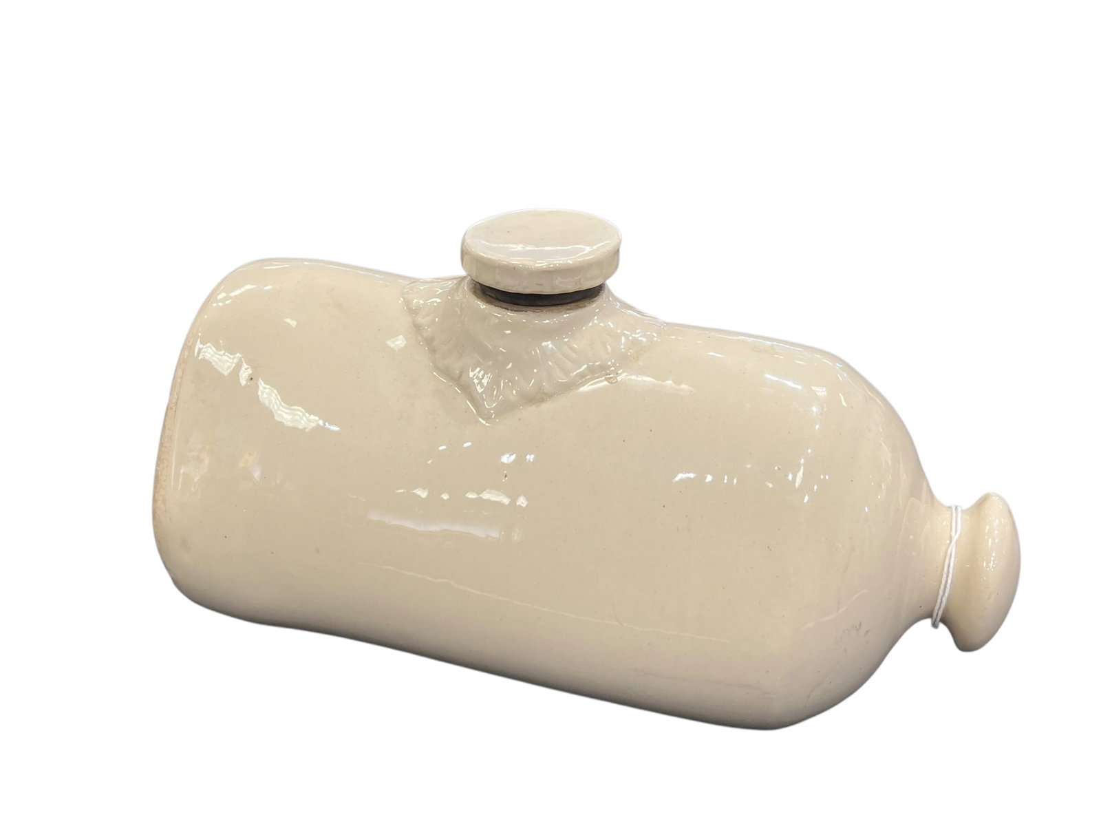 Stoneware Foot Warmer.: The image appears to show an antique Lovatts Langley Ware glazed stoneware foot warmer or hot water bottle from England, featuring a smooth cream-colored cylindrical body with a threaded ceramic
