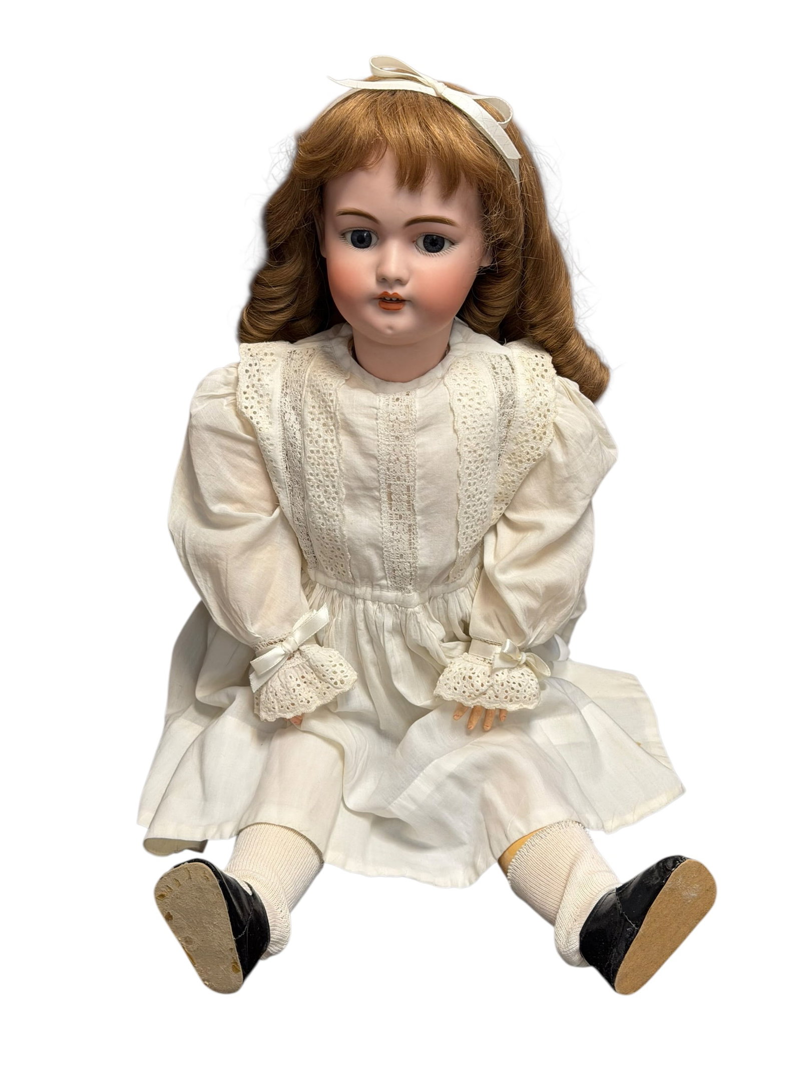 DEP Germany S&H 1079 Antique Porcelain or Bisque Head Doll: antique German bisque head doll wearing a white lace-trimmed dress and a hair bow, resembling styles produced by makers like Kestner or Simon & Halbig around the late 19th or early 20th century. [1, 2