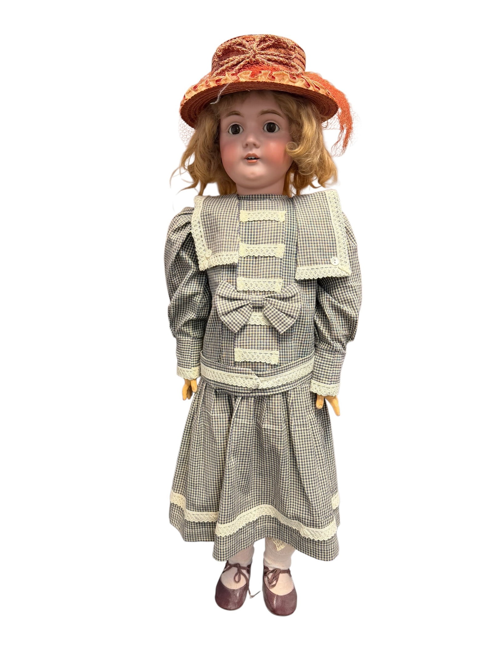 Made in Germany Porcelain or Bisque Head Doll: This is an antique German bisque-headed child doll, dating back to the late 19th or early 20th century. [1]Identification & FeaturesMaker Characteristics: Dolls matching this distinct style,