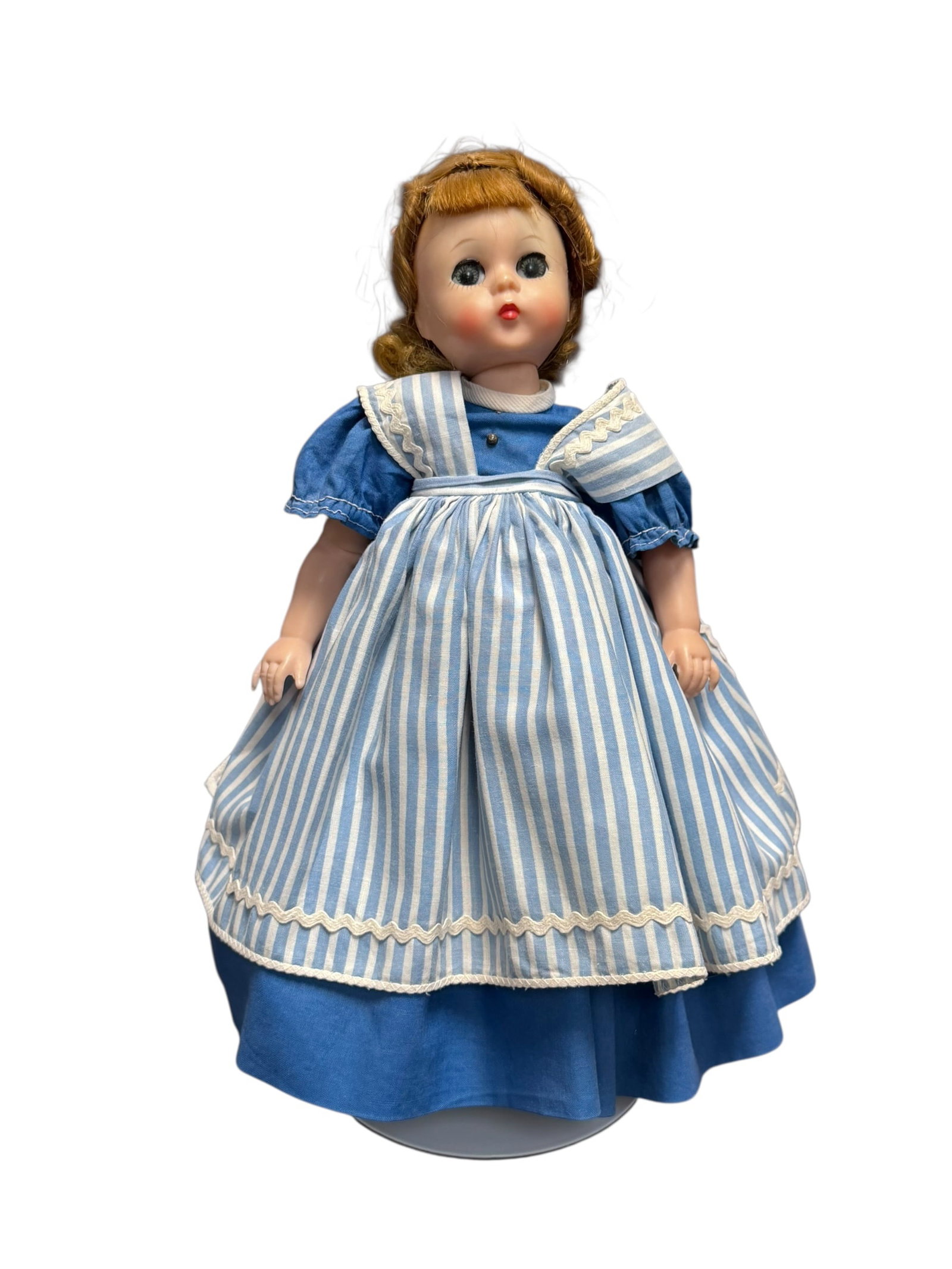 Madame Alexander Vinyl Doll: vintage Madame Alexander "Meg" doll from the Little Women series, likely made in the 1950s. [1, 2]Key Visual FeaturesFace and Hair: The doll features styled reddish-brown hair and painted facial