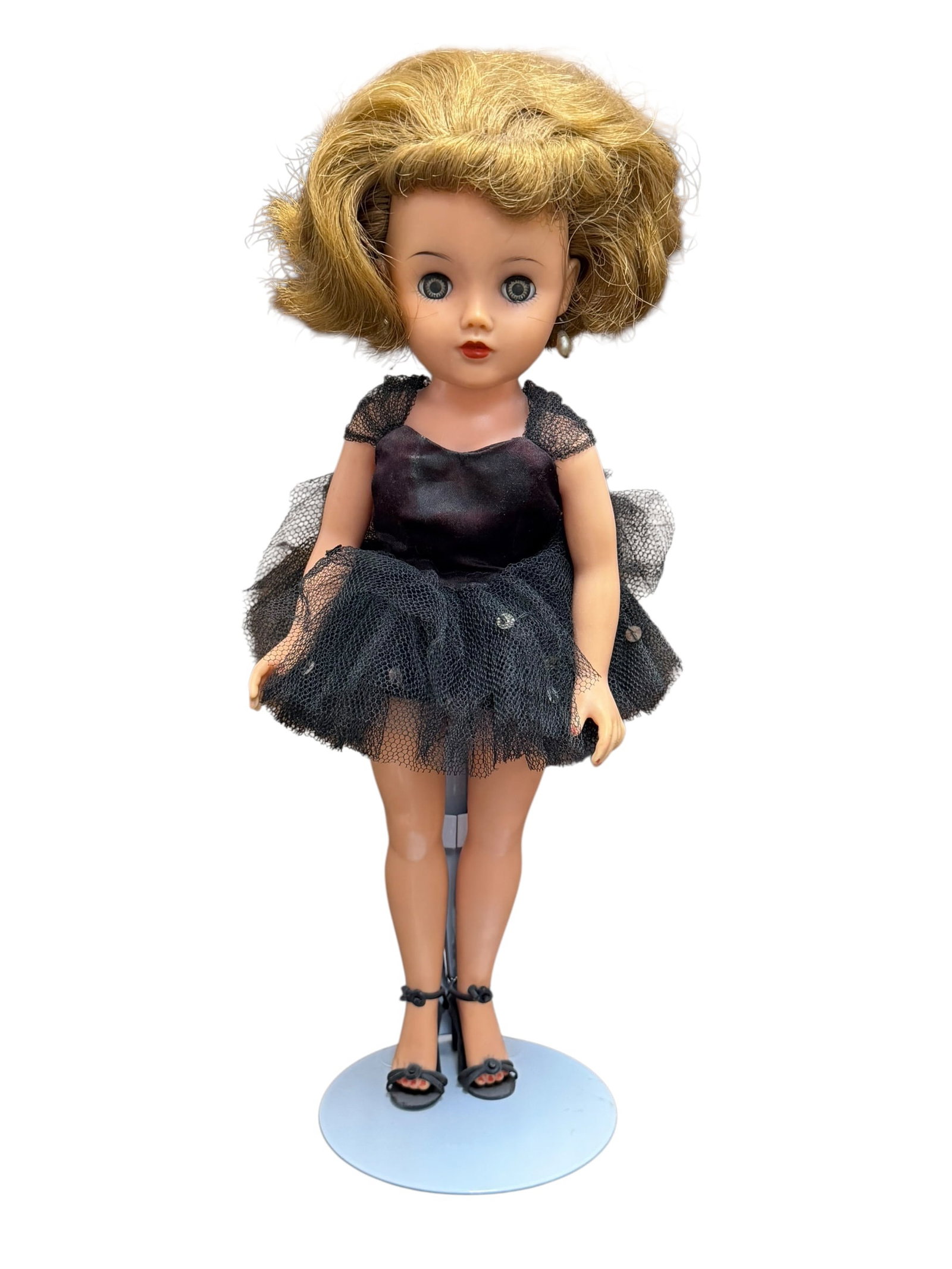 1950’s Ideal “Miss Revlon?? Fashion Doll: vintage 1950s Ideal Miss Revlon Ballerina Doll featuring short blonde hair, sleep eyes, and a black tulle tutu dress with matching black strappy ballet heels.Doll FeaturesAppearance: Vinyl fashion