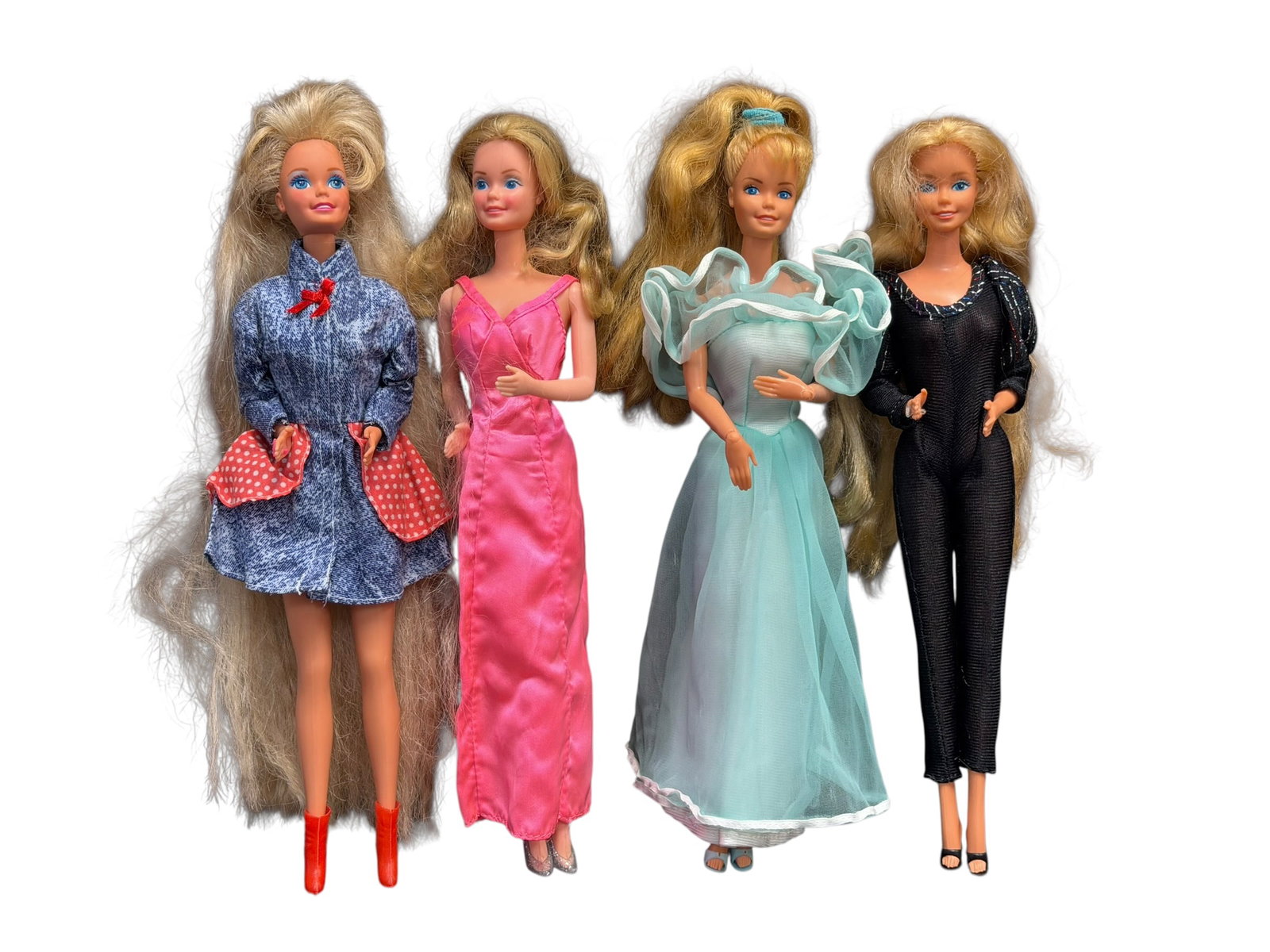 Lot of 4 Barbie Dolls: collection of four vintage Mattel Barbie fashion dolls from the 1980s, each styled with unique blonde hair and distinct retro outfits.Far Left Doll: Features exceptionally long, crinkled blonde hair, 