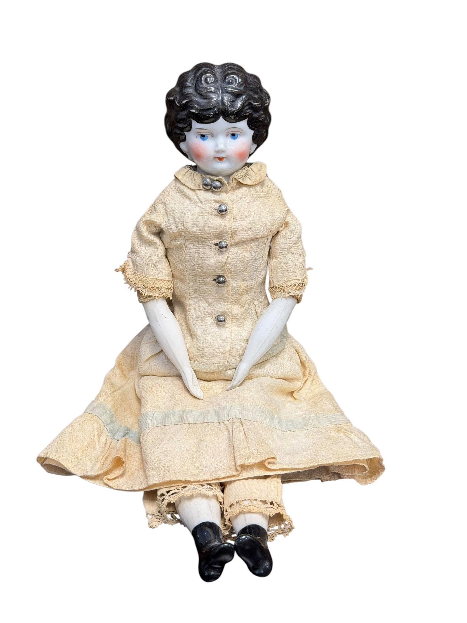 Antique Glazed Porcelain China Head Doll: antique German china head doll with molded dark curly hair, painted facial features, and a cloth or sawdust-filled body wearing a pale fabric outfit. [1, 2]Key DetailsType: Antique china head (porcela