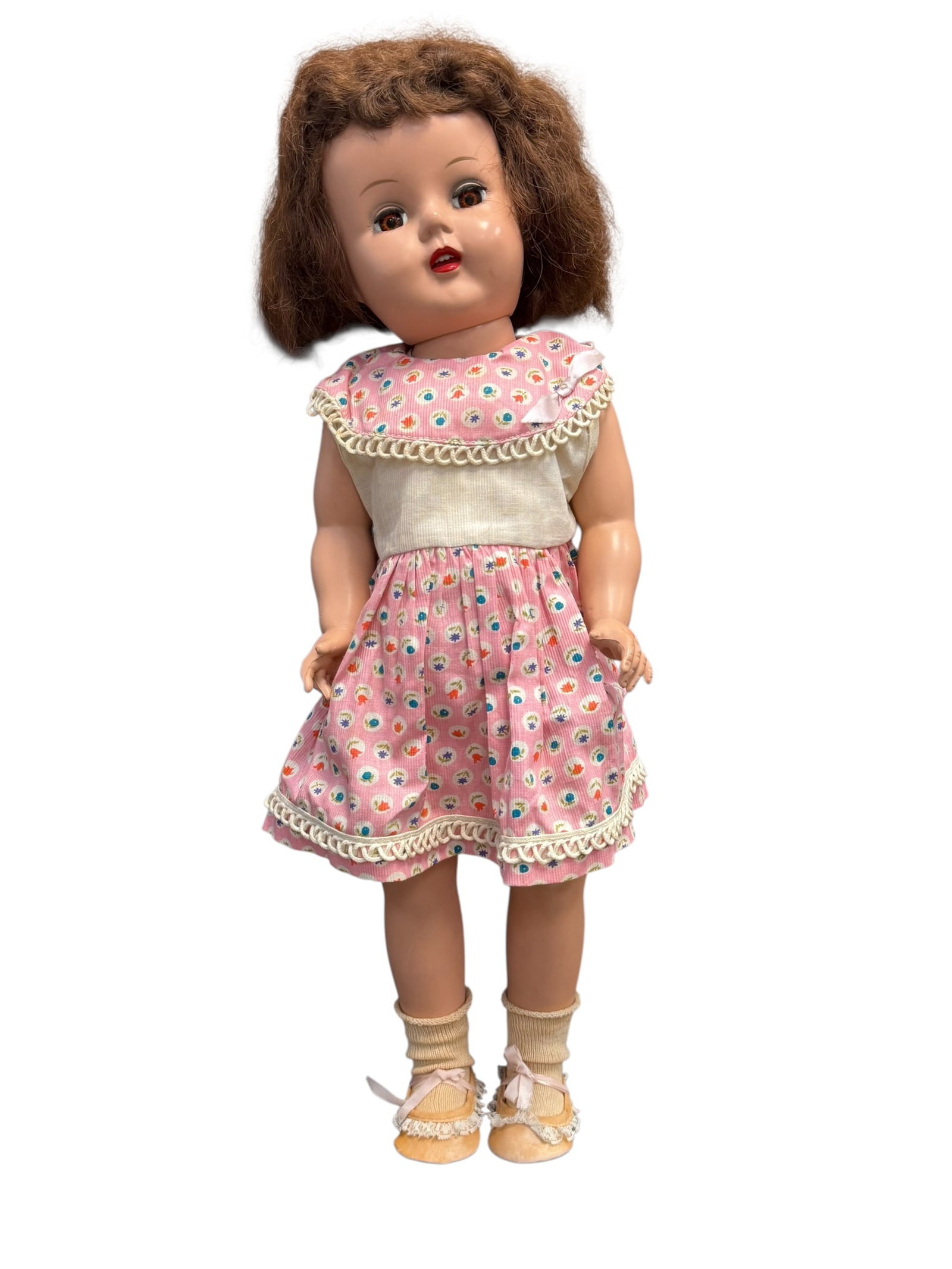 Hard Plastic Character Doll: This doll is a vintage Saucy Walker doll, originally manufactured by the Ideal Toy Company during the 1950s. [1]Key Features & IdentificationFace Mold: She features the distinct chubby-cheeked, open-m