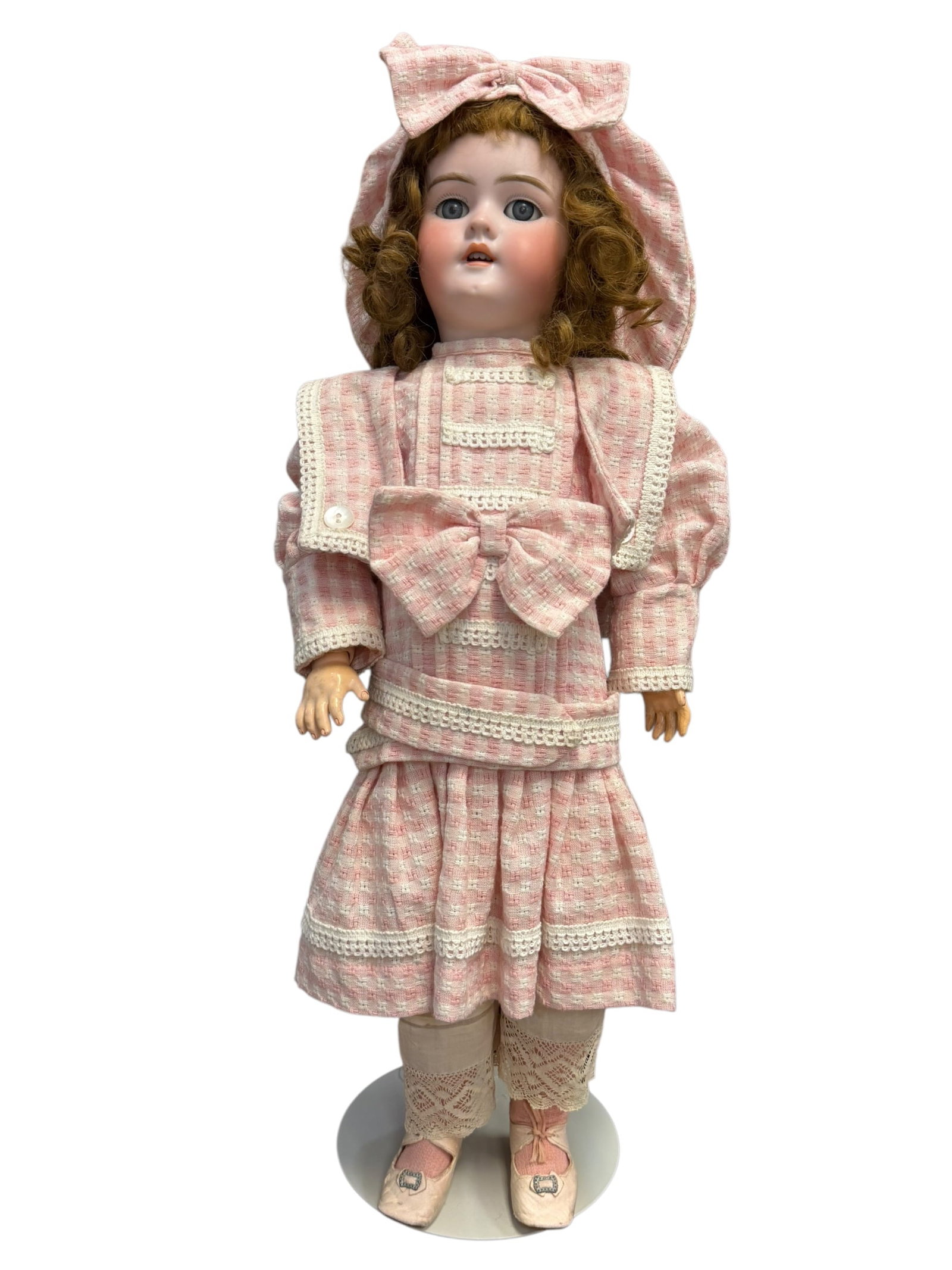 German Handwerck Bisque Socket Head Doll: This is an antique bisque doll, likely crafted in Germany or France between the late 19th and early 20th centuries. She features a finely detailed bisque socket head, expressive glass sleep eyes,