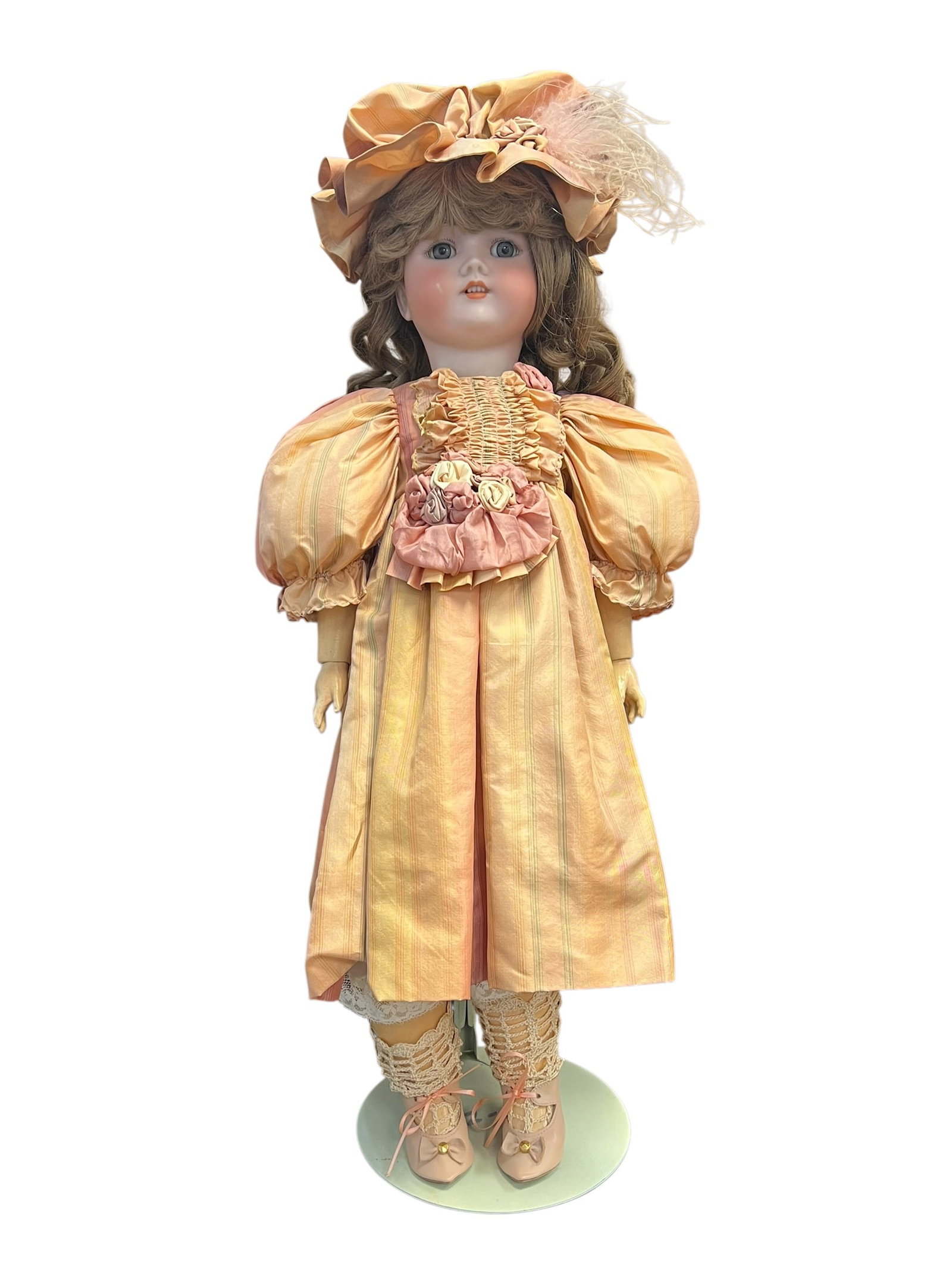 CM Birgmann Porcelain Head Doll: vintage porcelain or bisque-head collector doll dressed in a Victorian-style peach and yellow striped gown with a matching bonnet. [1, 2]Features a bisque porcelain head and shoulder plate with painte